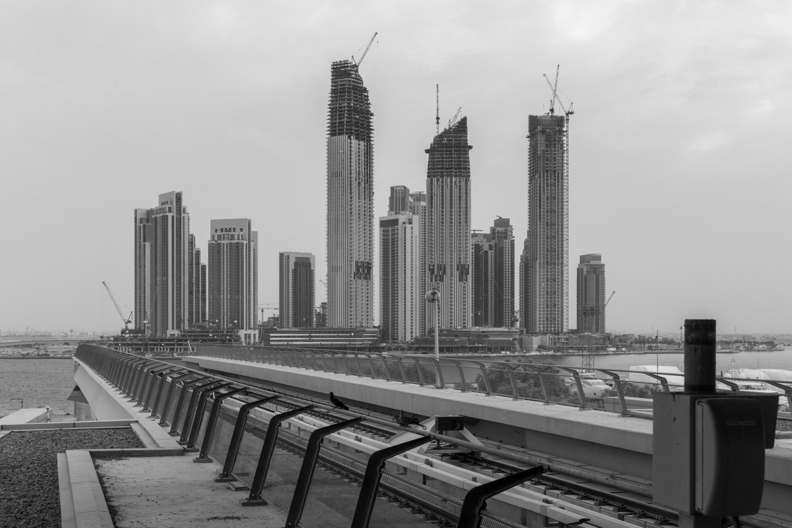 This image captures the modern skyline of the United Arab Emirates, highlighting rapid urban growth and architectural transformation since the creation of UAE in 1971. The high-rise buildings under construction symbolize how UAE got independence and evolved into a global center for innovation and development.
