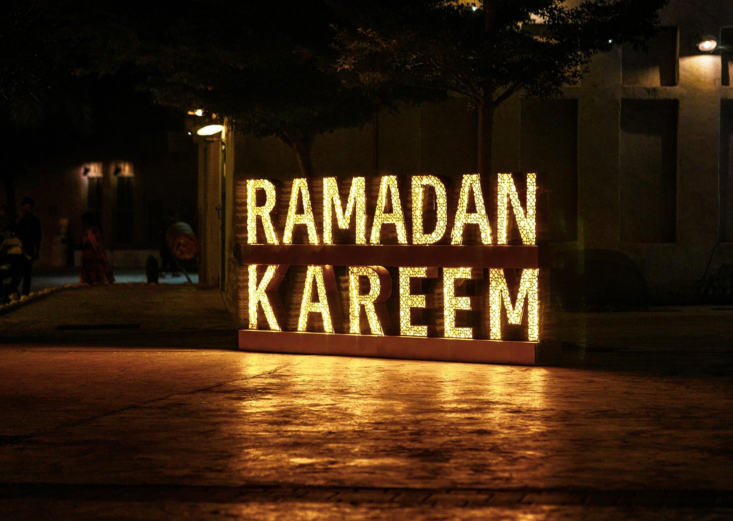 Illuminated "Ramadan Kareem" sign at night during the Islamic year's holiest month
