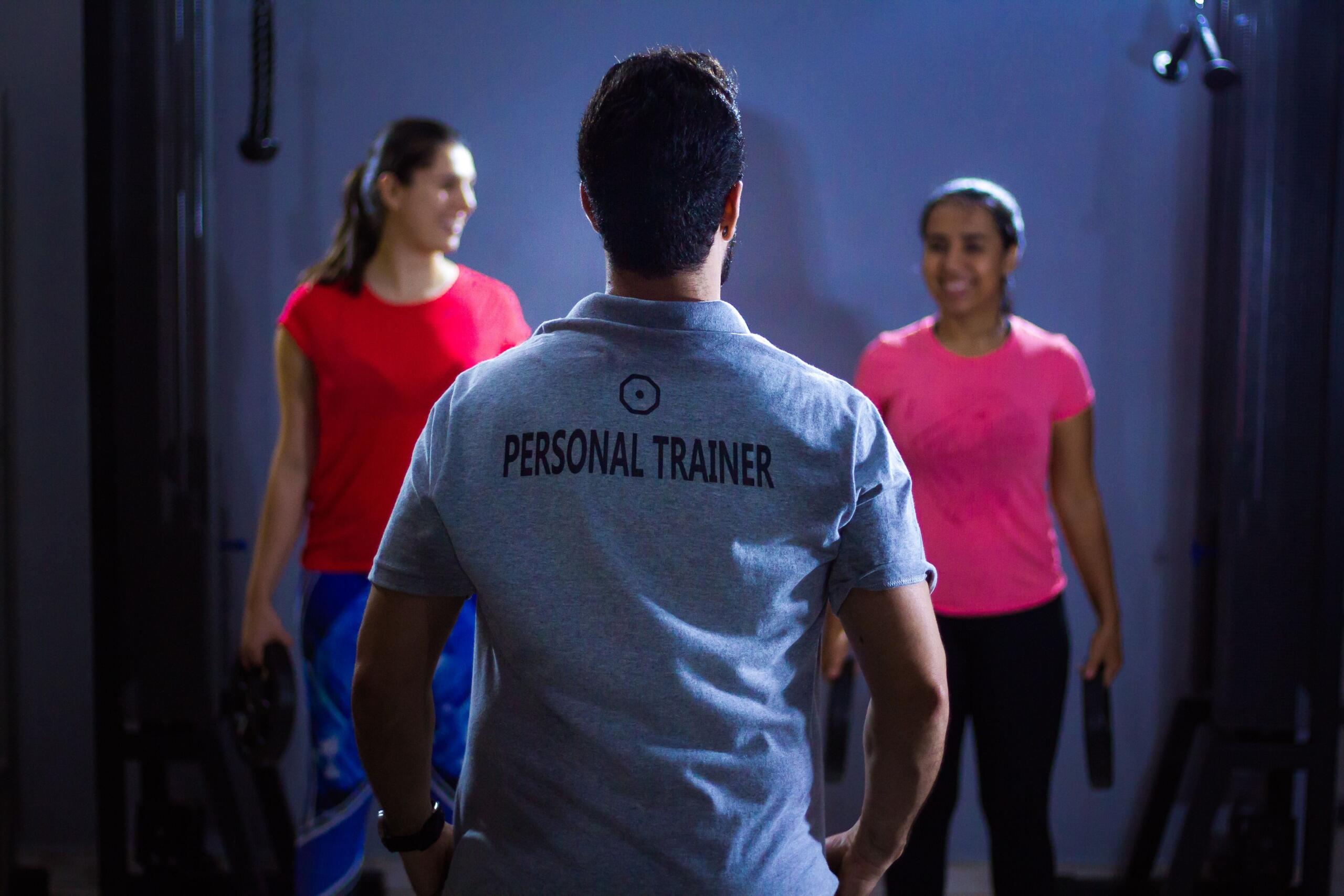Personal trainer talking to 2 clients