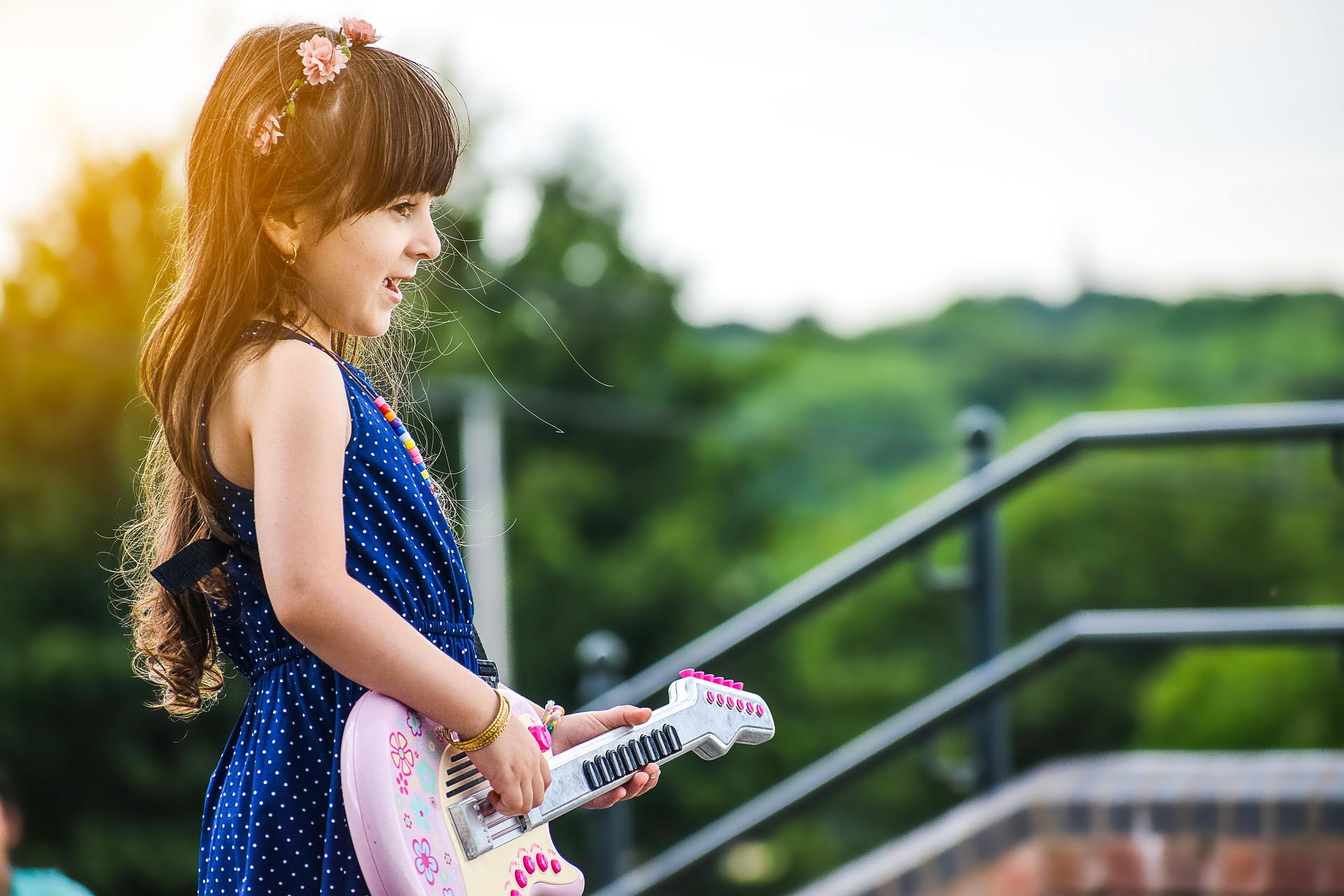 Niña tocando una guitarra