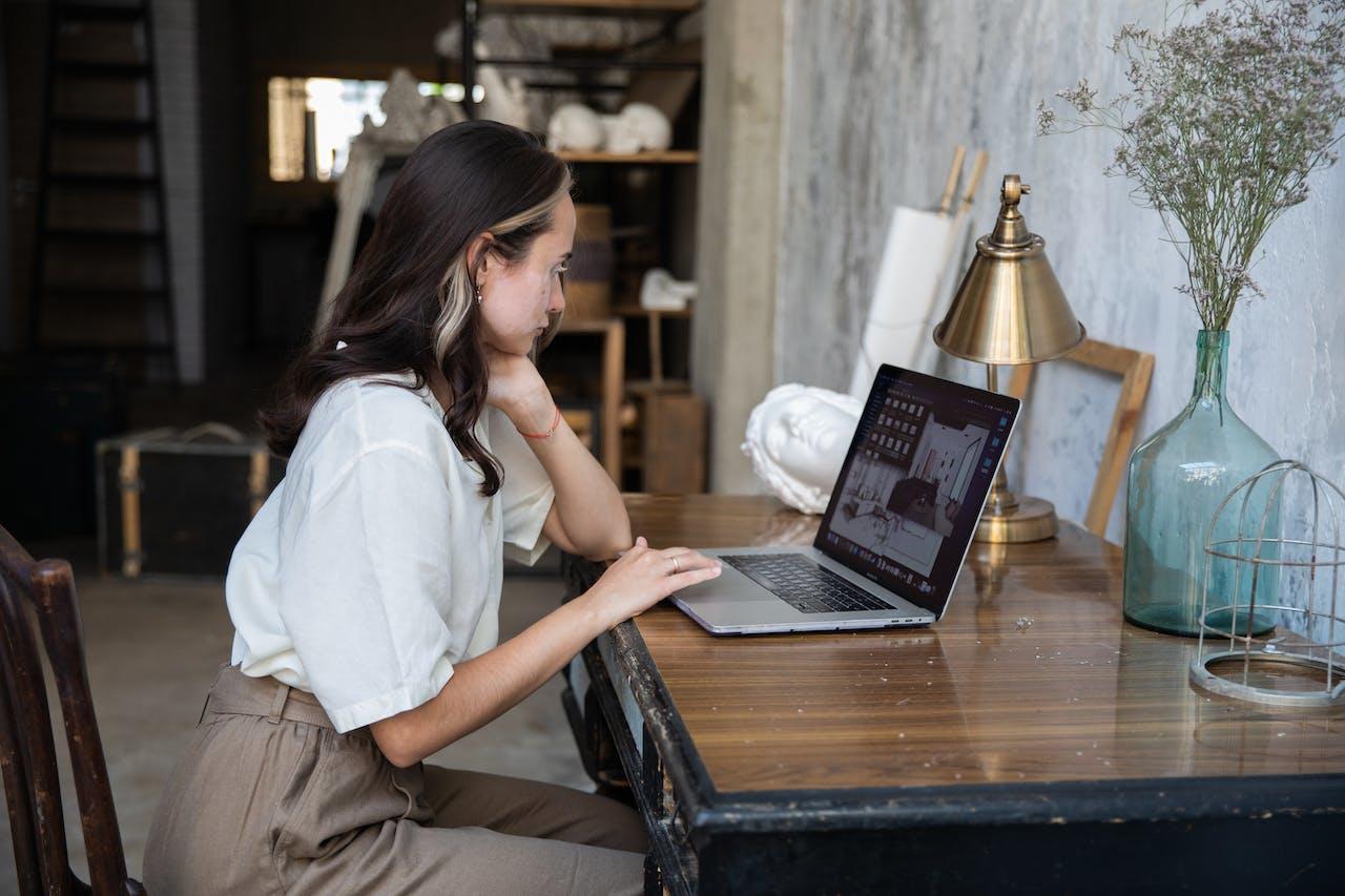 Mujer sentada en el escritorio frente a la computadora.