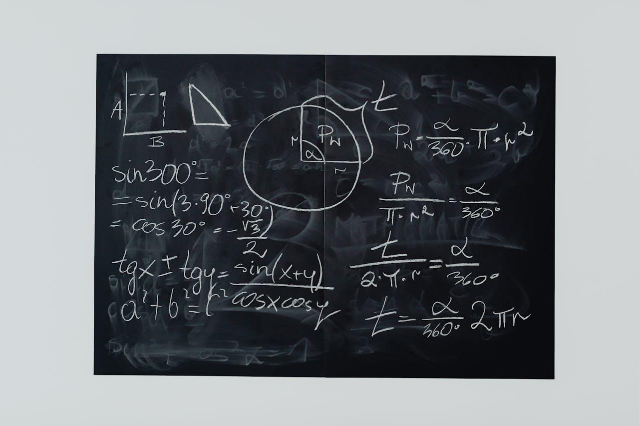 Escrituras matemáticas en un pizarrón negro.