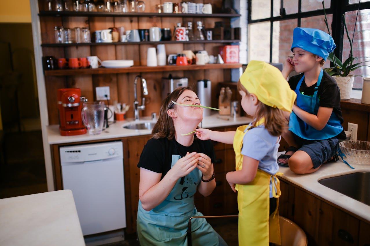 Mujer y niños cocinando en la cocina.