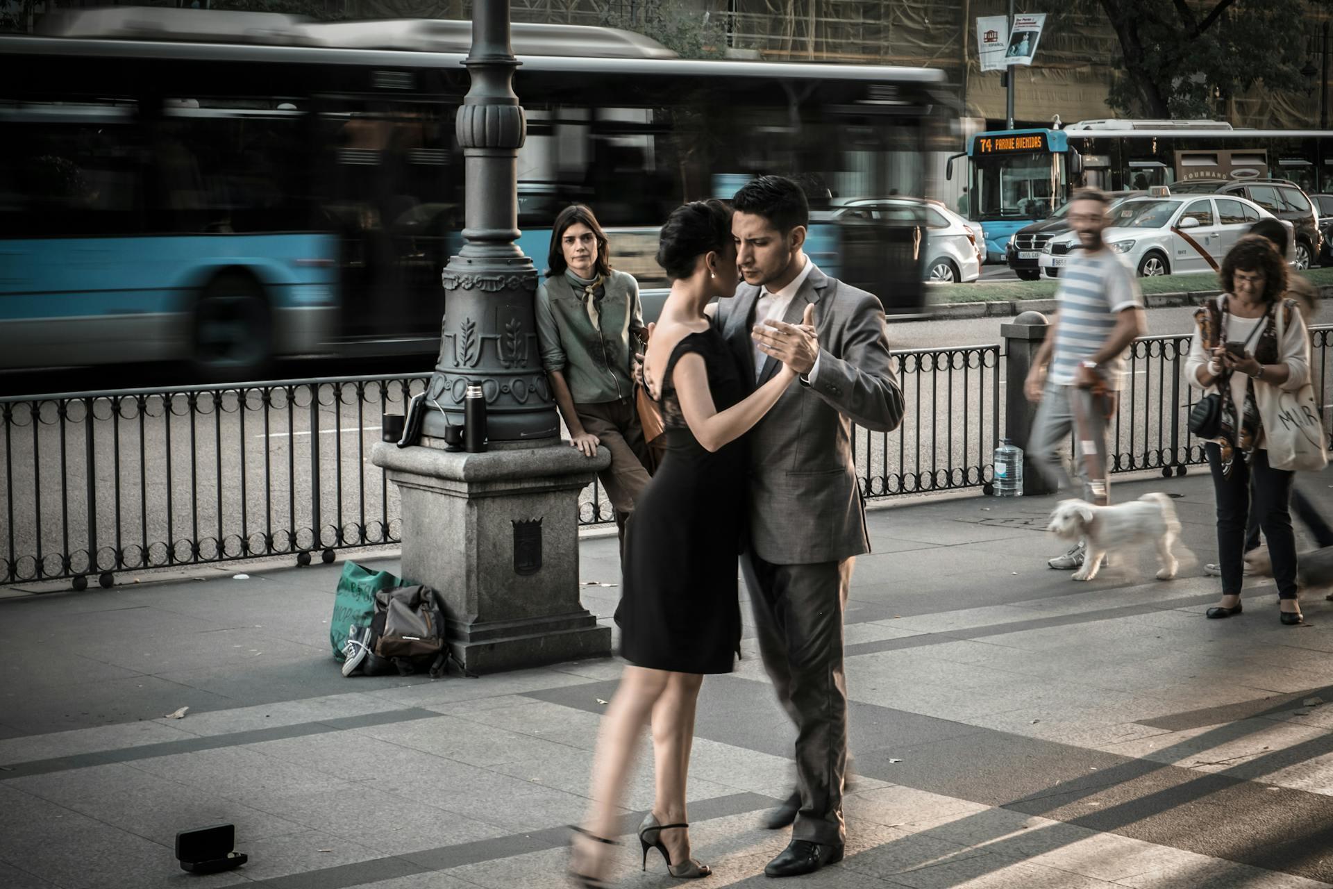 Pareja bailando en la vereda.