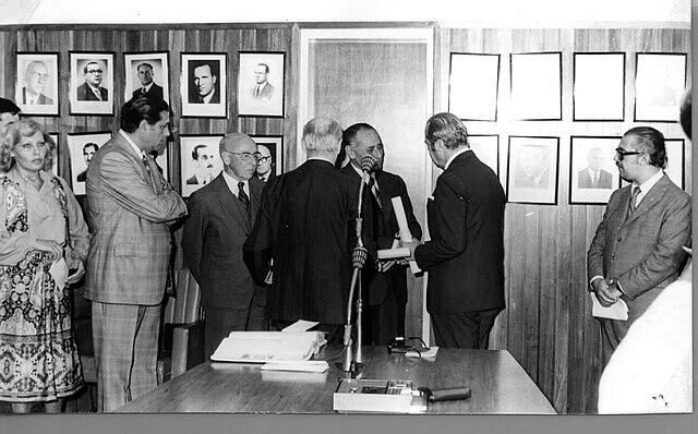 Hombres parados detrás del micrófono.