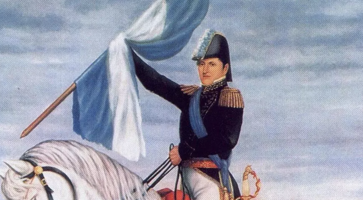 Argentina, 1812. Manuel Belgrano izando la Escarapela Argentina con uniforme militar. Pintura histórica, Wikimedia Commons.