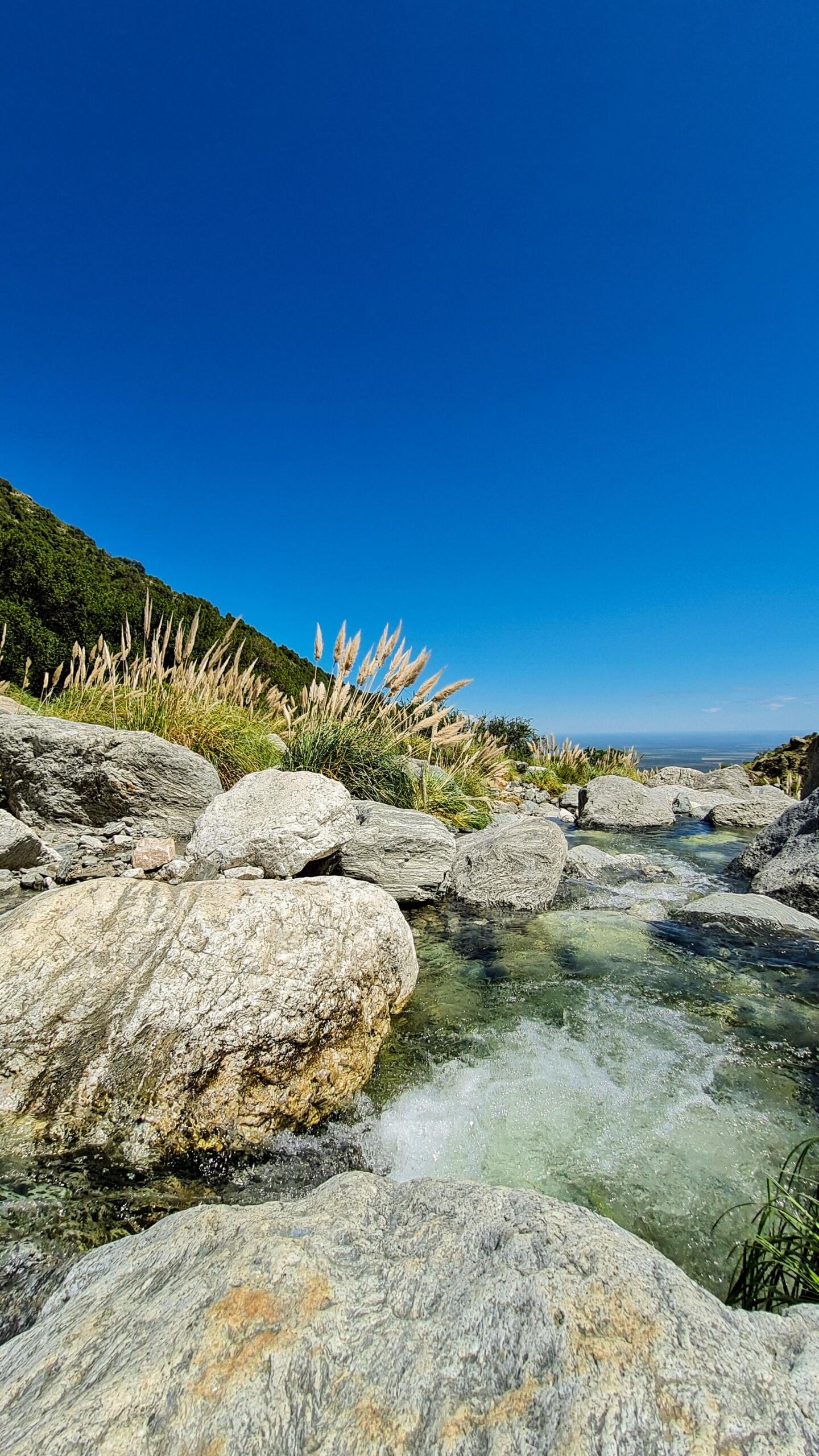 Paisaje de río rocoso en un día soleado.