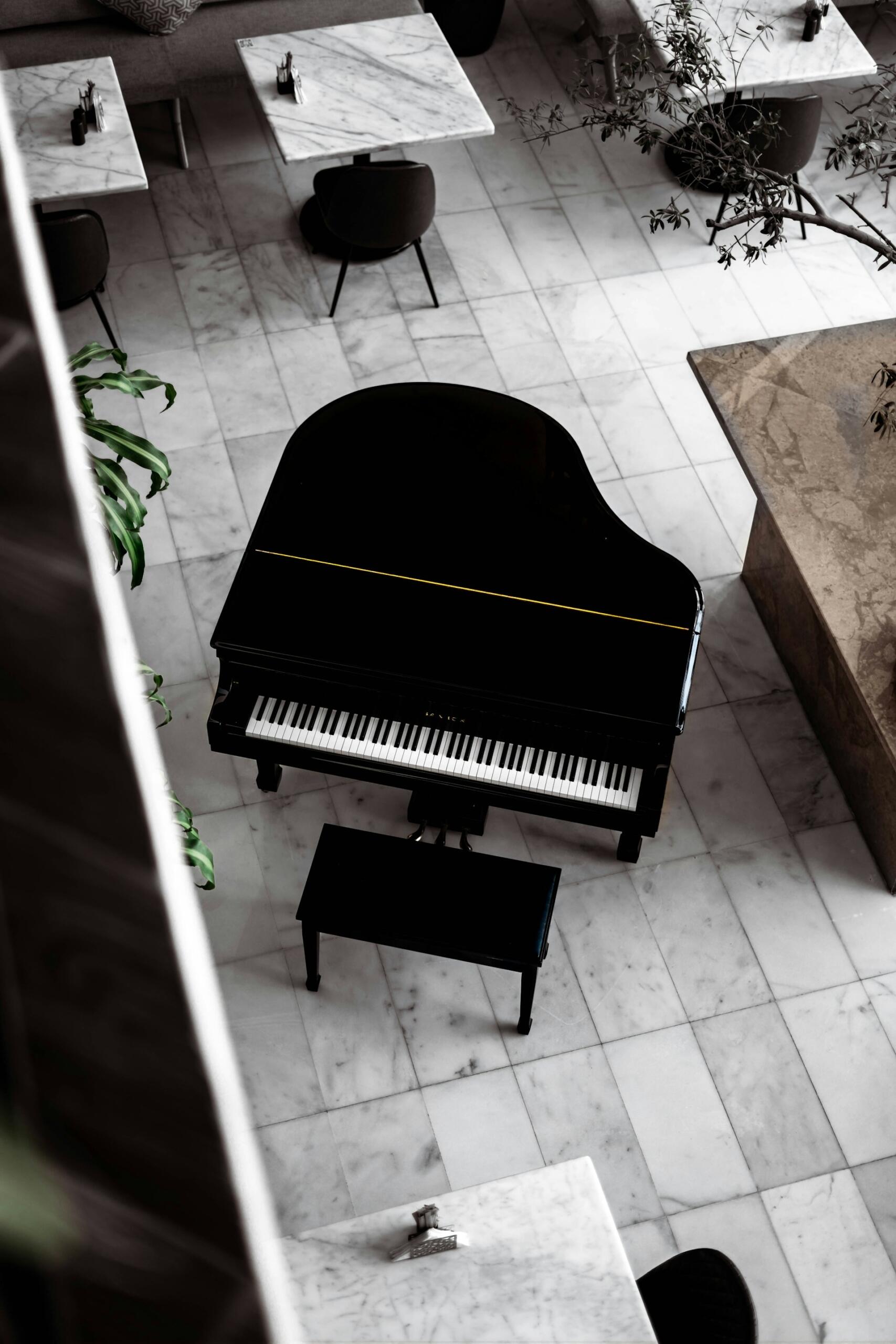 A baby grand piano in an open space.