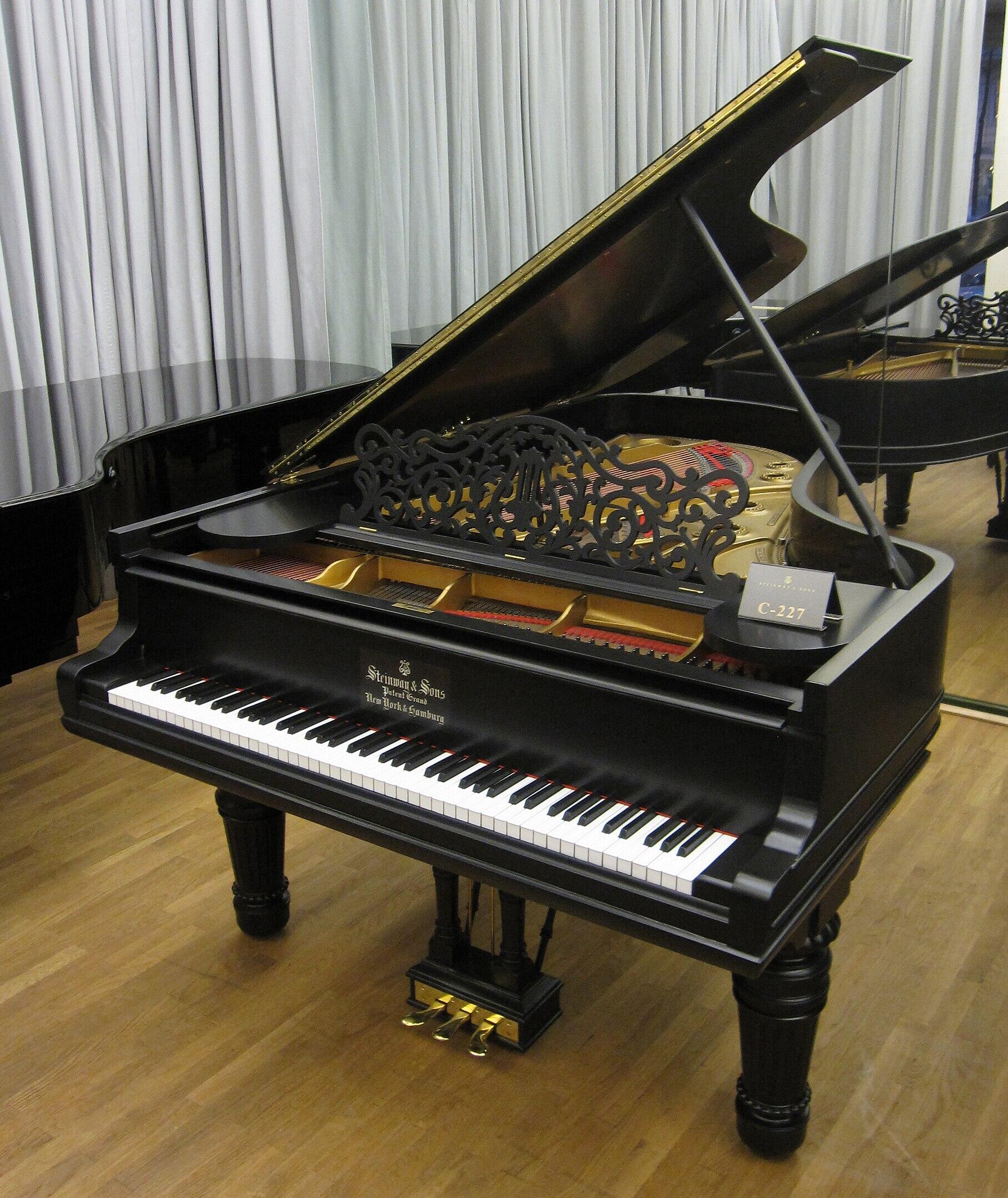 A grand piano with open lid.