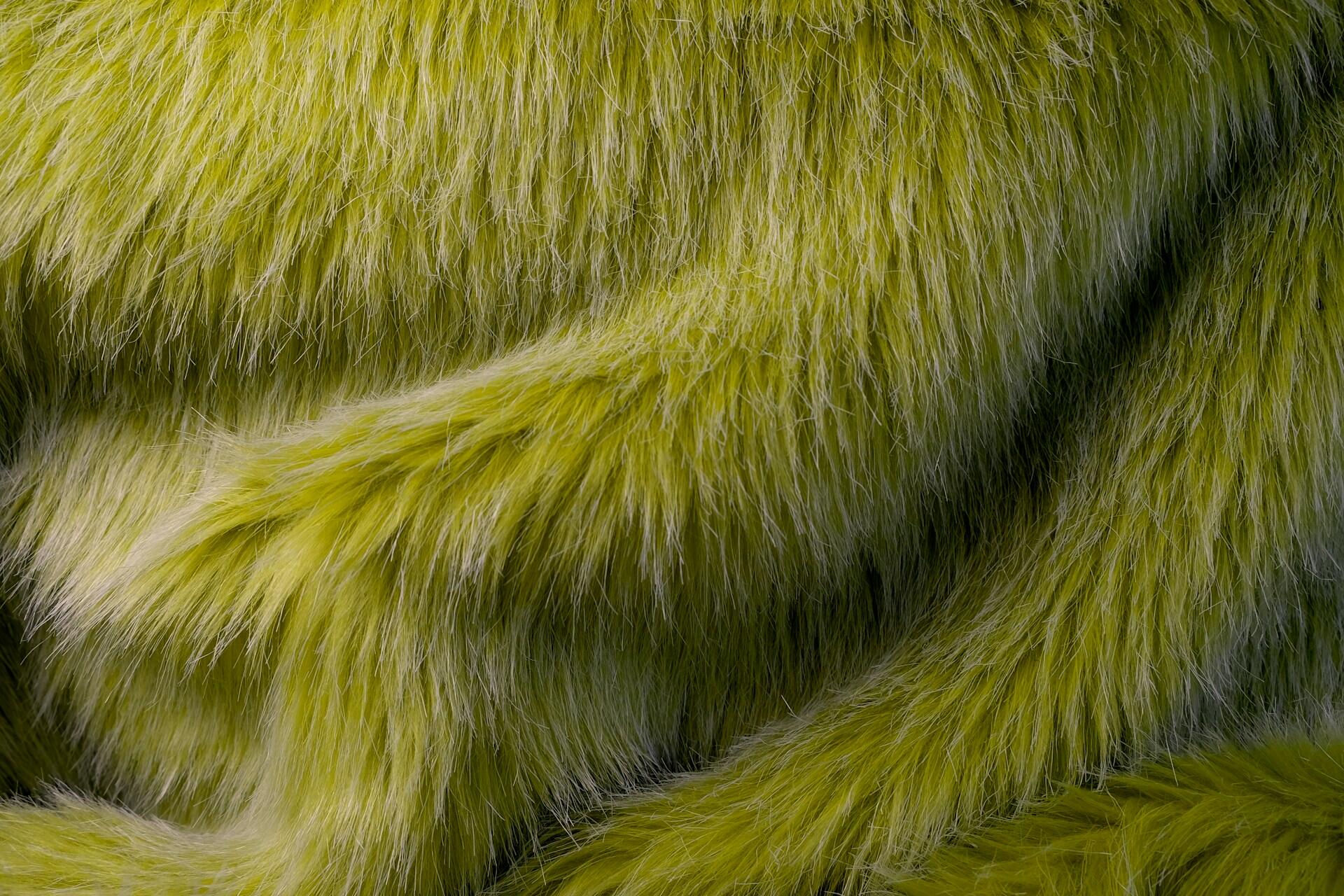 Green faux fur fabric with long strands going in one direction