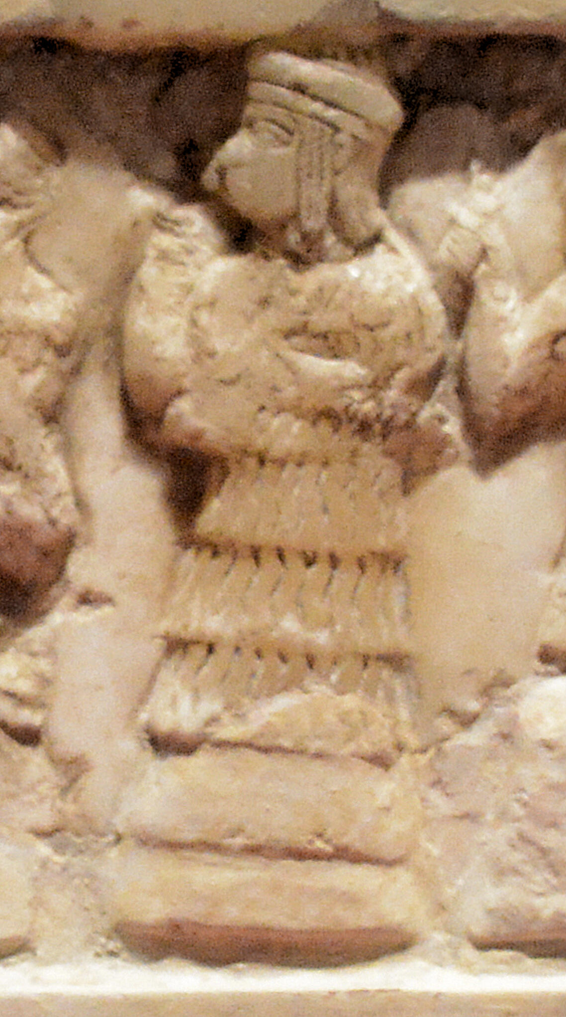 photo of the carving of Enheduanna found on an ancient stone disk
