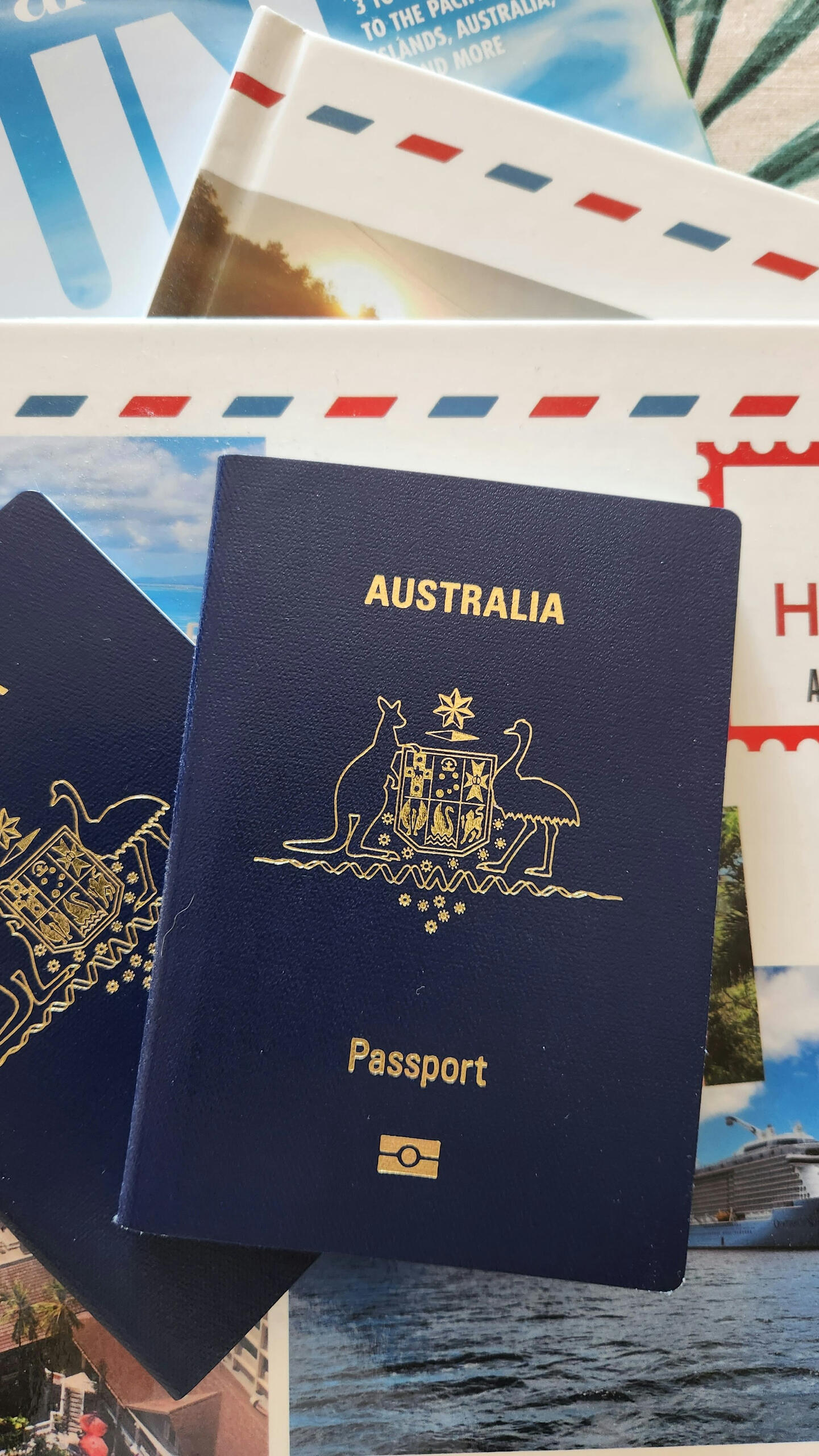 an Australian passport laying on top of travel books