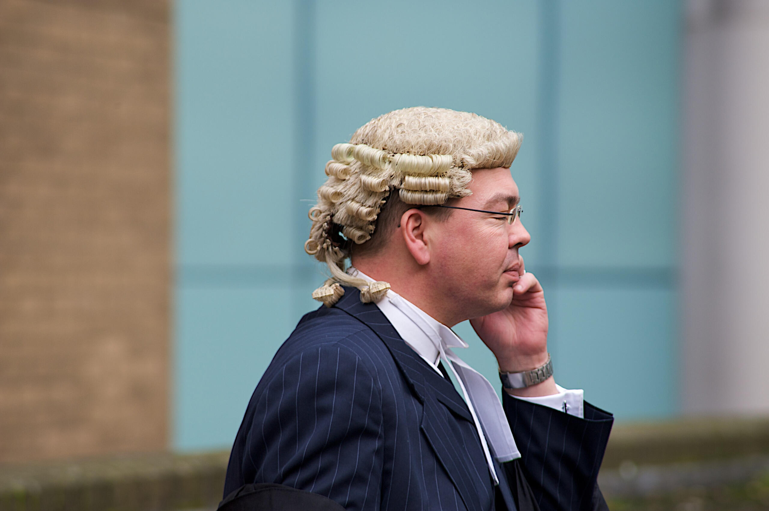 a barrister on a mobile phone wearing the distinguishing powdered wig