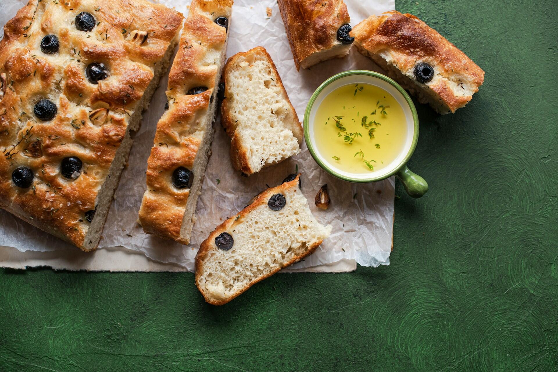 fluffy homemade bread with a small cup of herbed olive oil