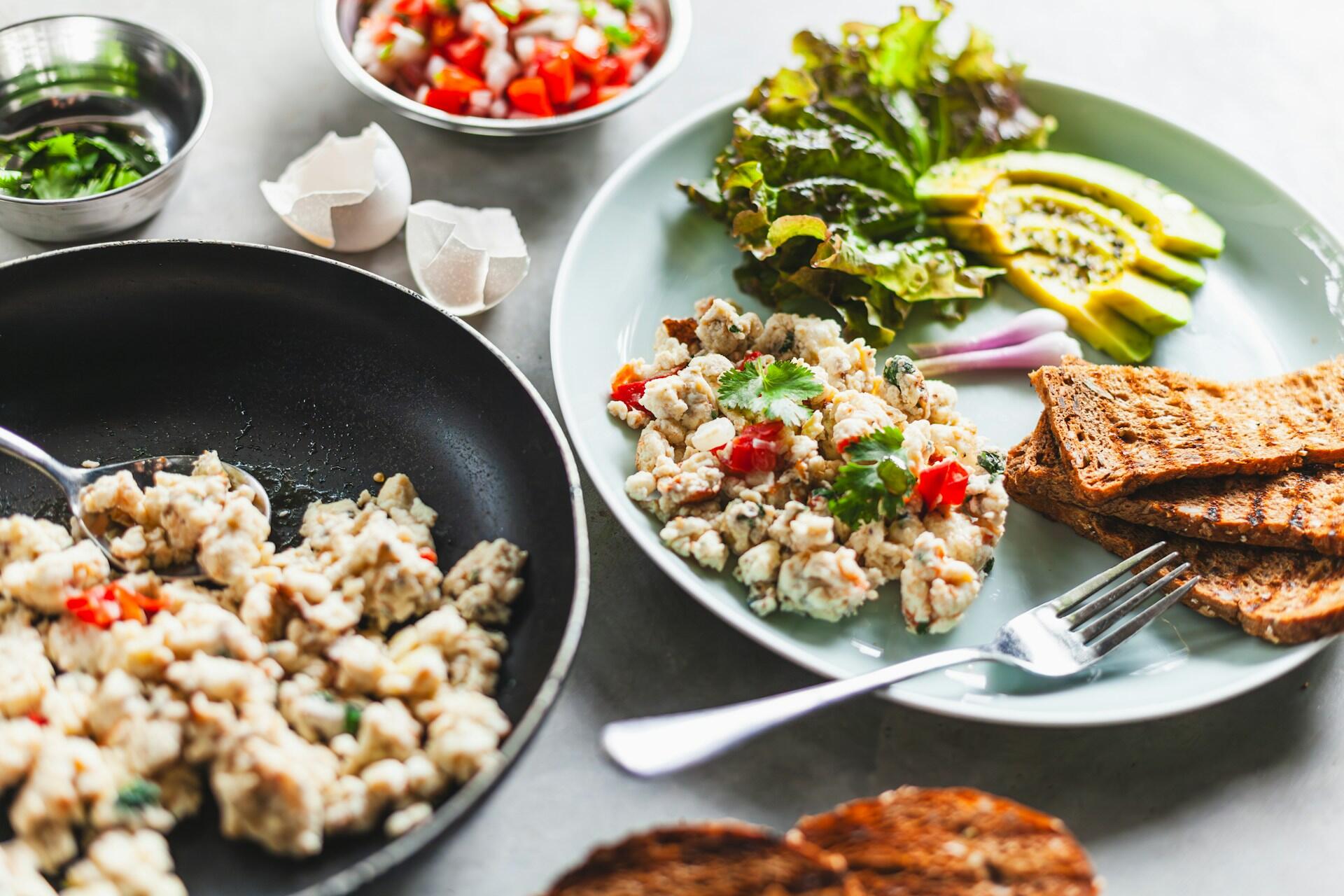 plate with scrambled eggs and vegetables with toast