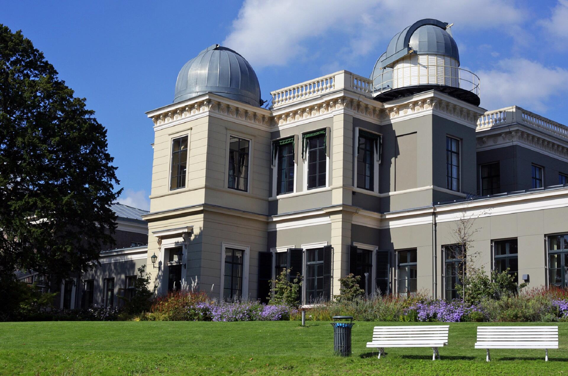 A stone building with domed roofs on a sunny day.