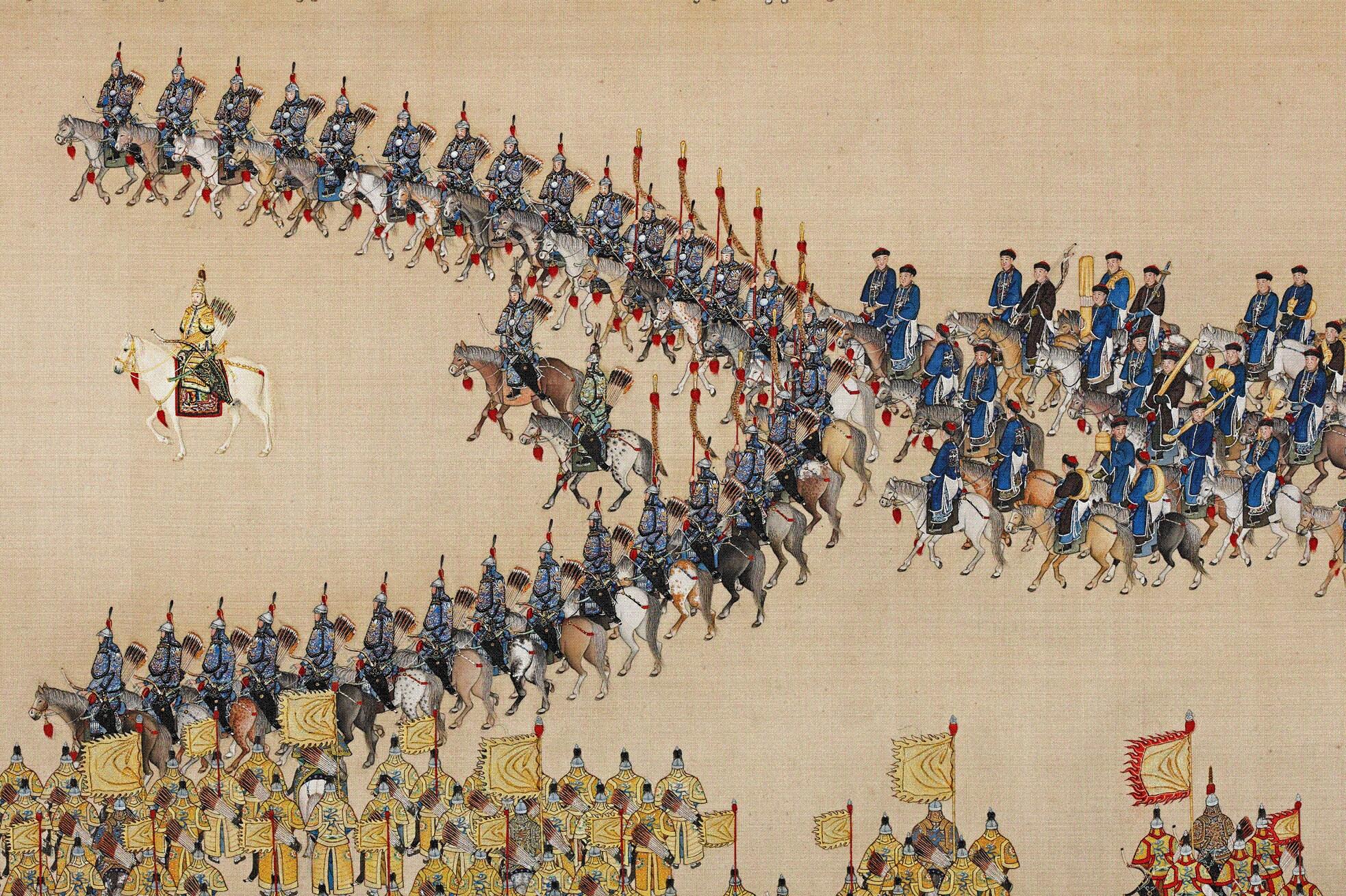 A horse rider among a half-circle of mounted men with ground troops carrying various coloured banners stand for inspection.