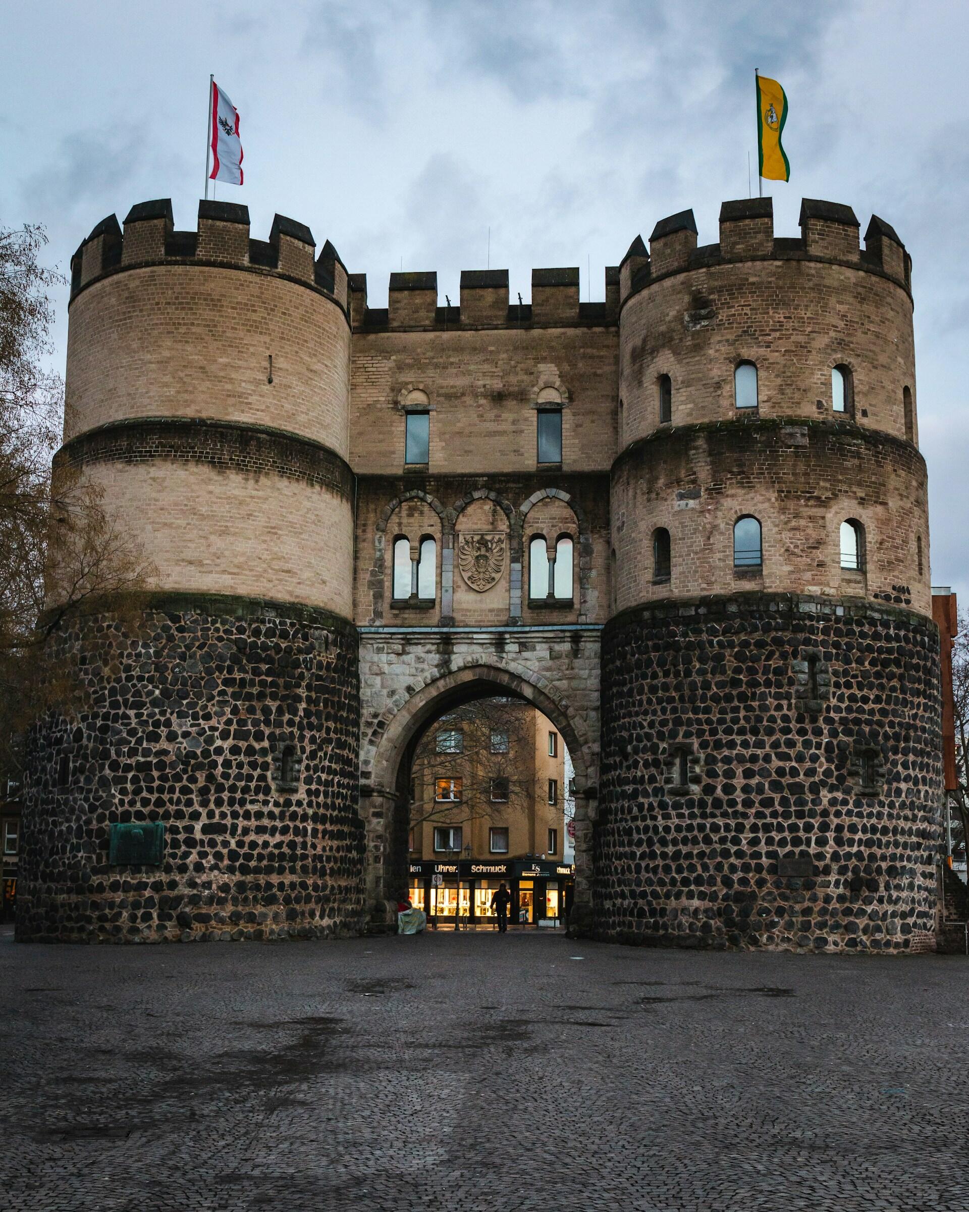 A castle with turrets topped with flags. 