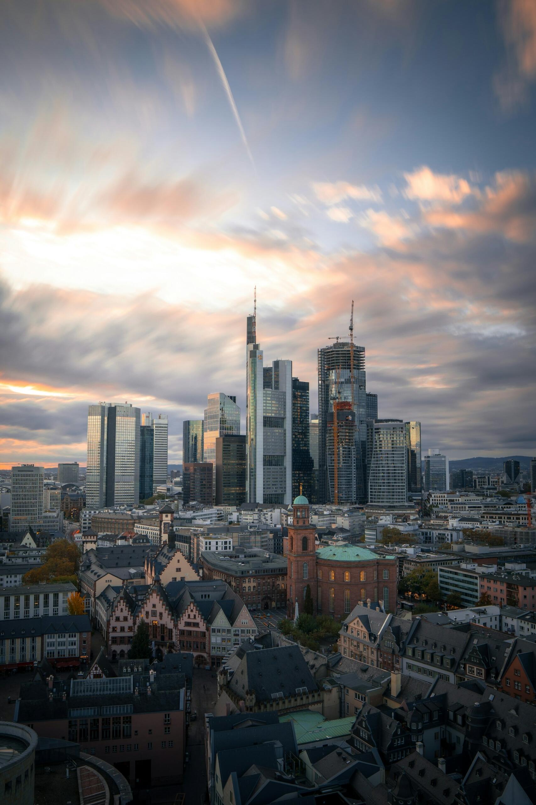 A city skyline with highrises in the background at sunset. 