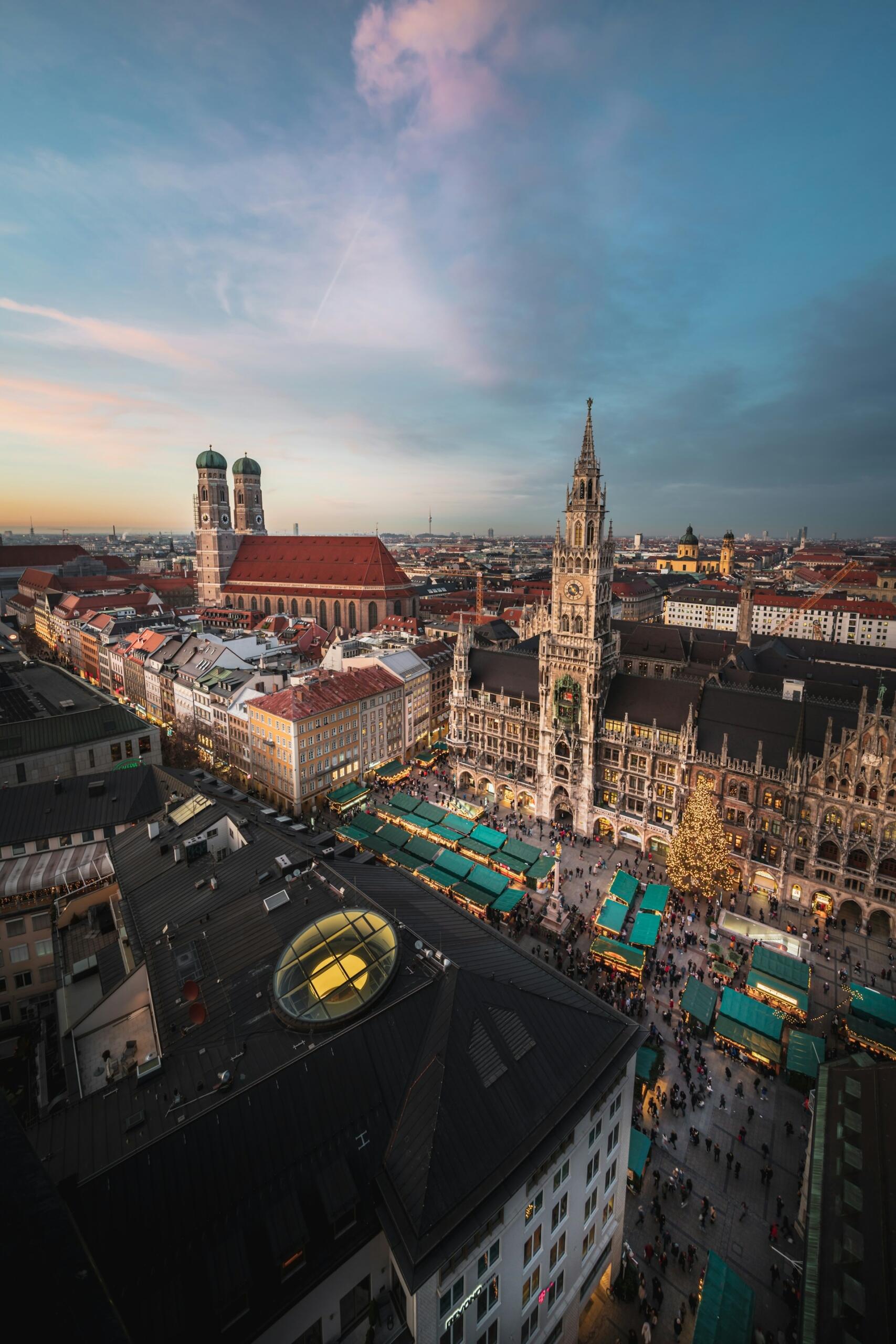 An aerial view of a city square, featuring many statuesque buildings. 