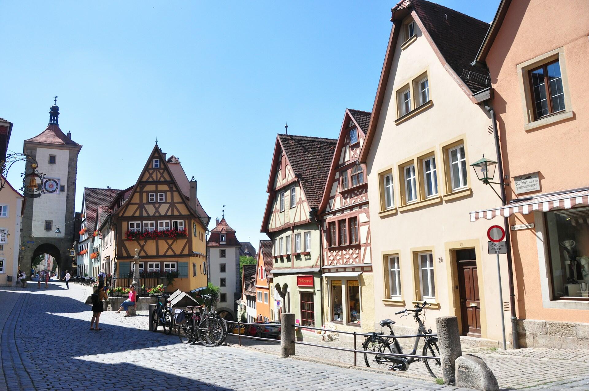 Bicycles in front of a brown building on a sunny day. 