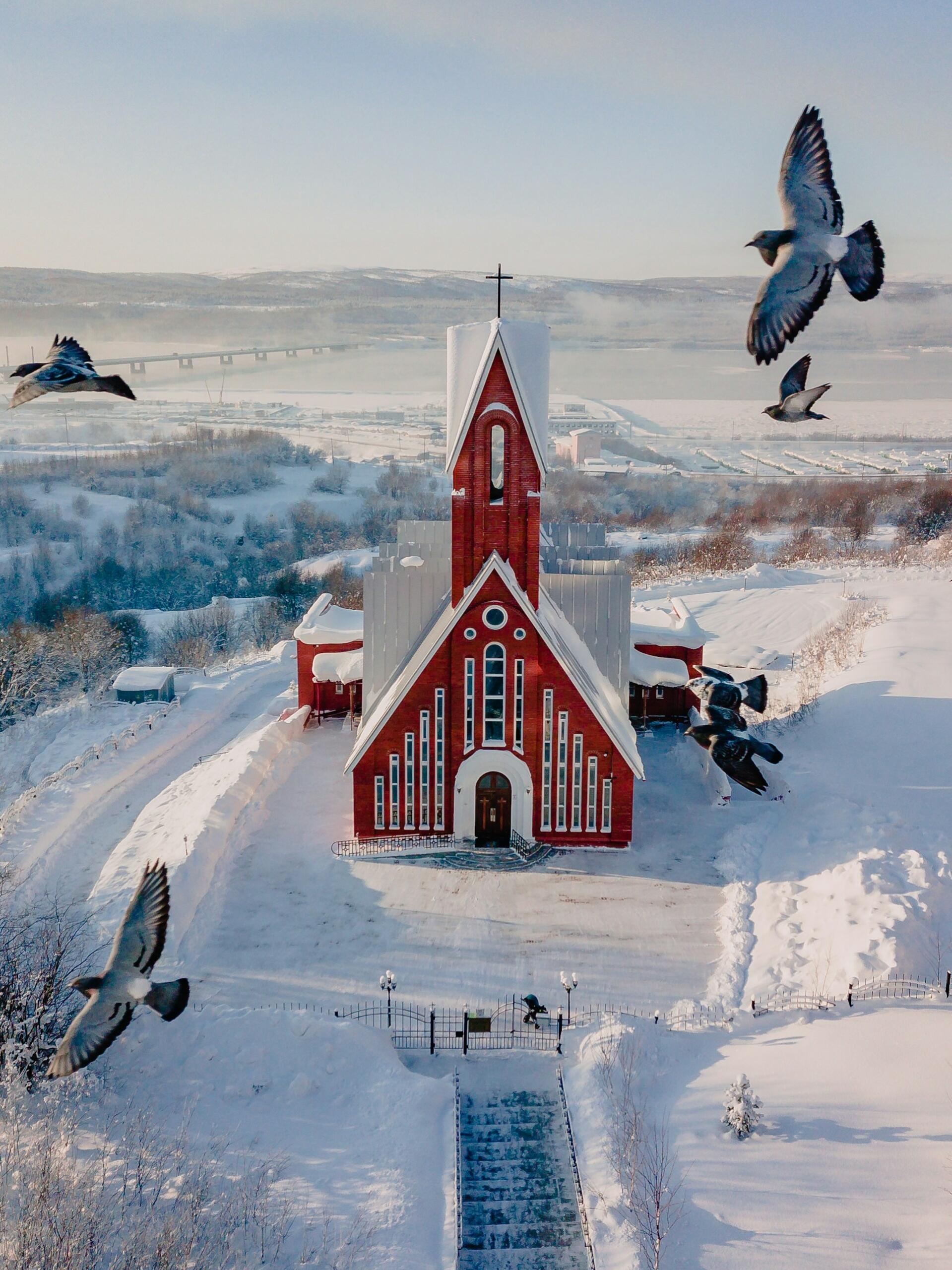 A red church in a snowy land.