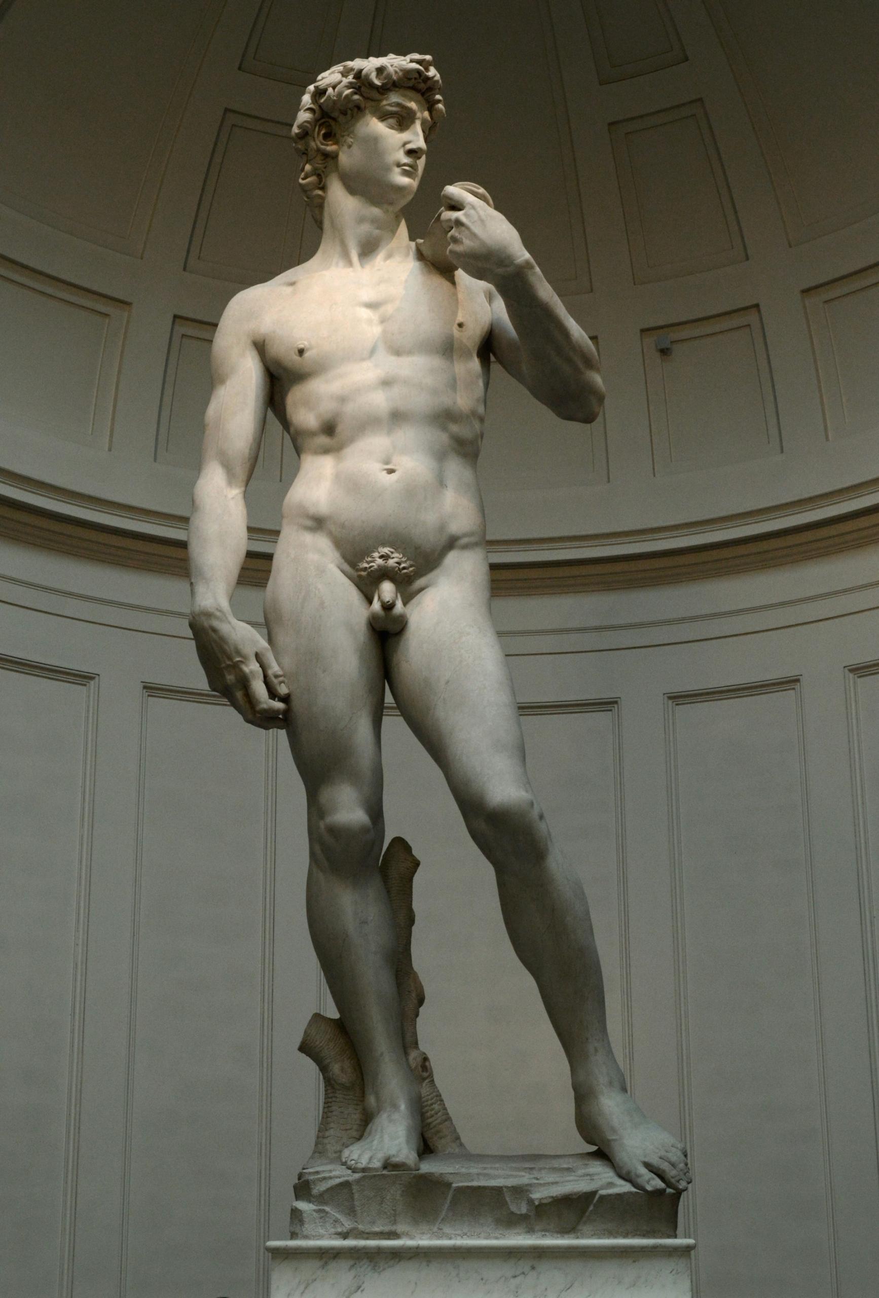 A statue of a nude male in an alcove 
