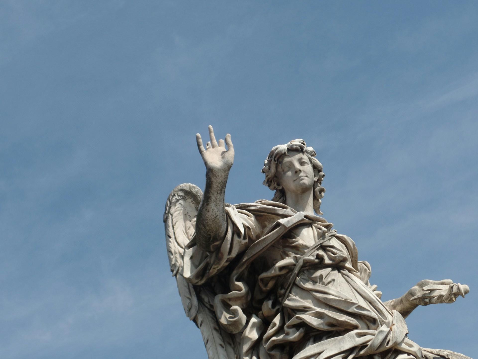 A stone statue against a blue sky.