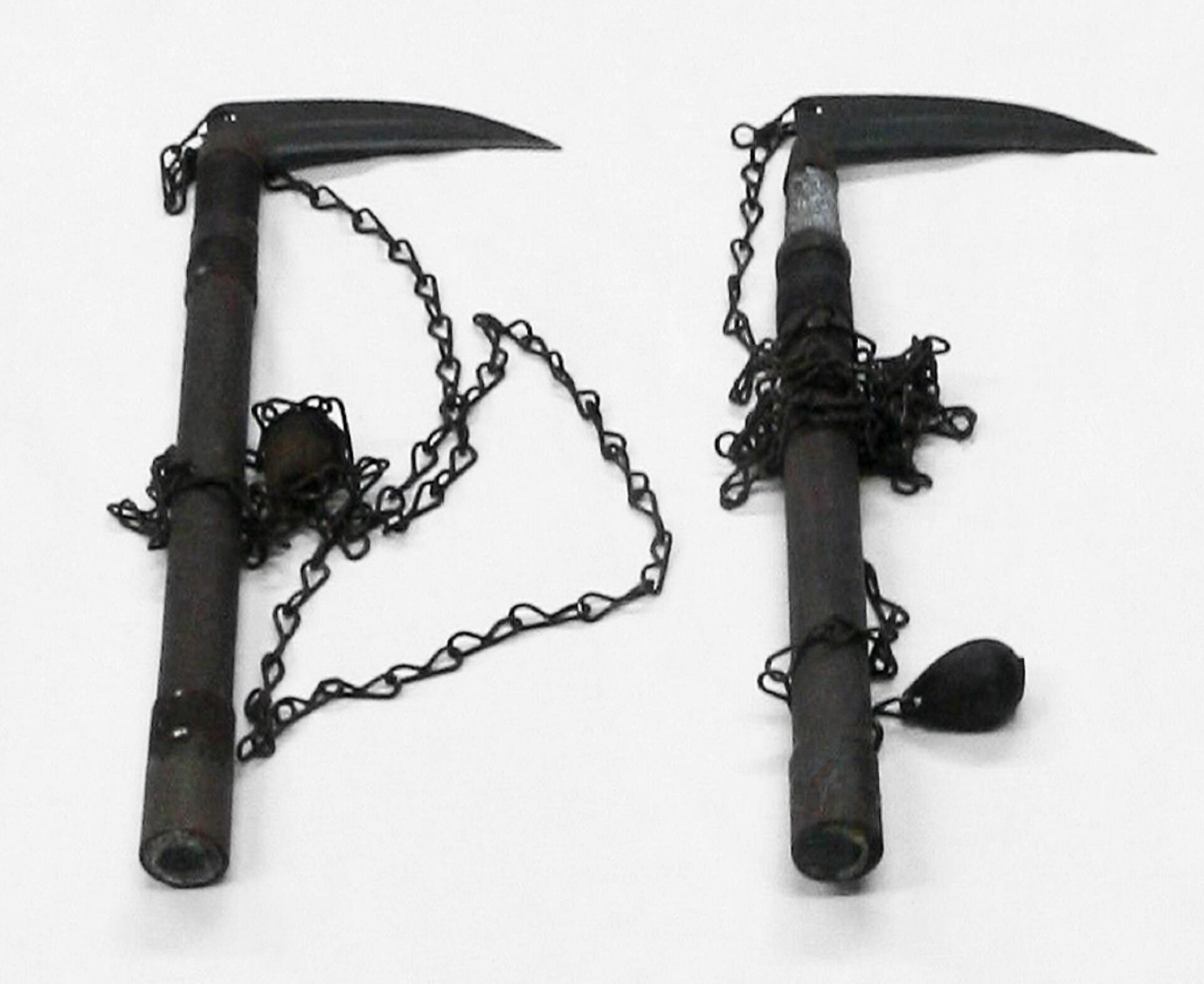 Two Japanaese medieval weapons featuring blades and weighted chains. 