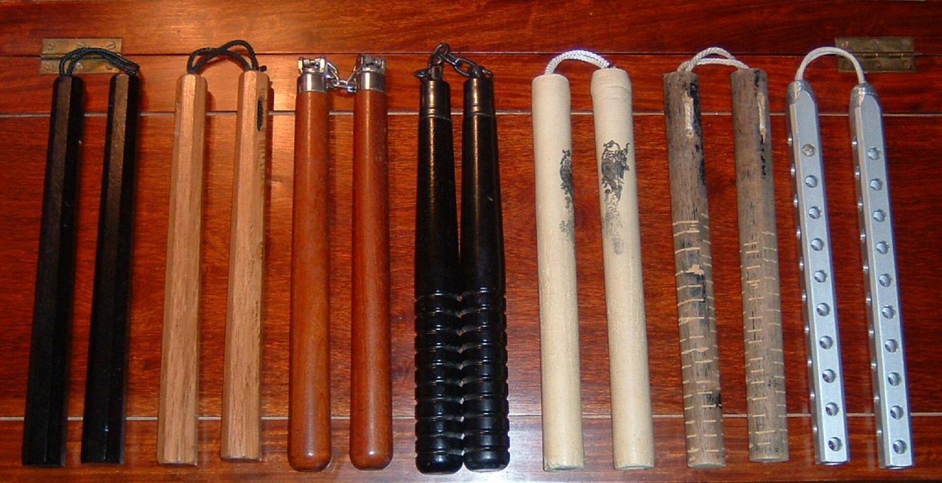 A row of nunchakus made from different materials. 