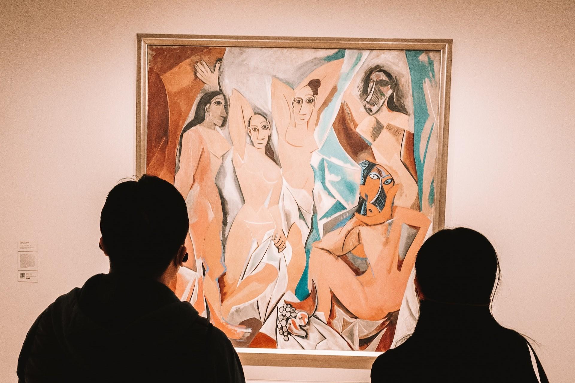 Two people looking at a Picasso in a museum.