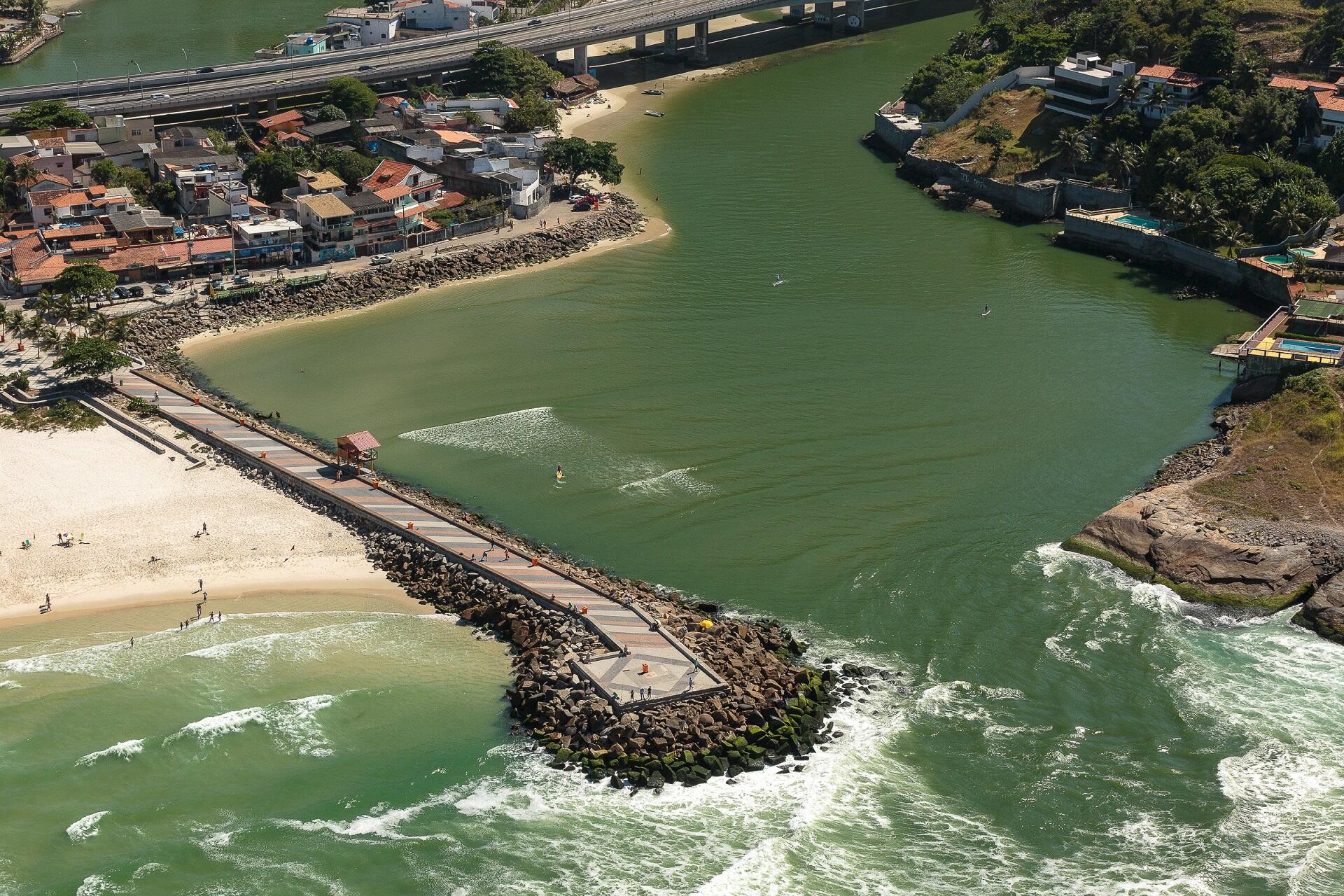Two breakwaters forming an aperture that restricts water flow. 