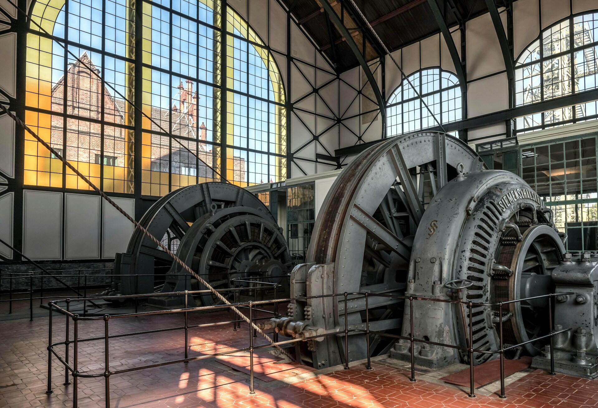 Two power generators in a glass-walled building.