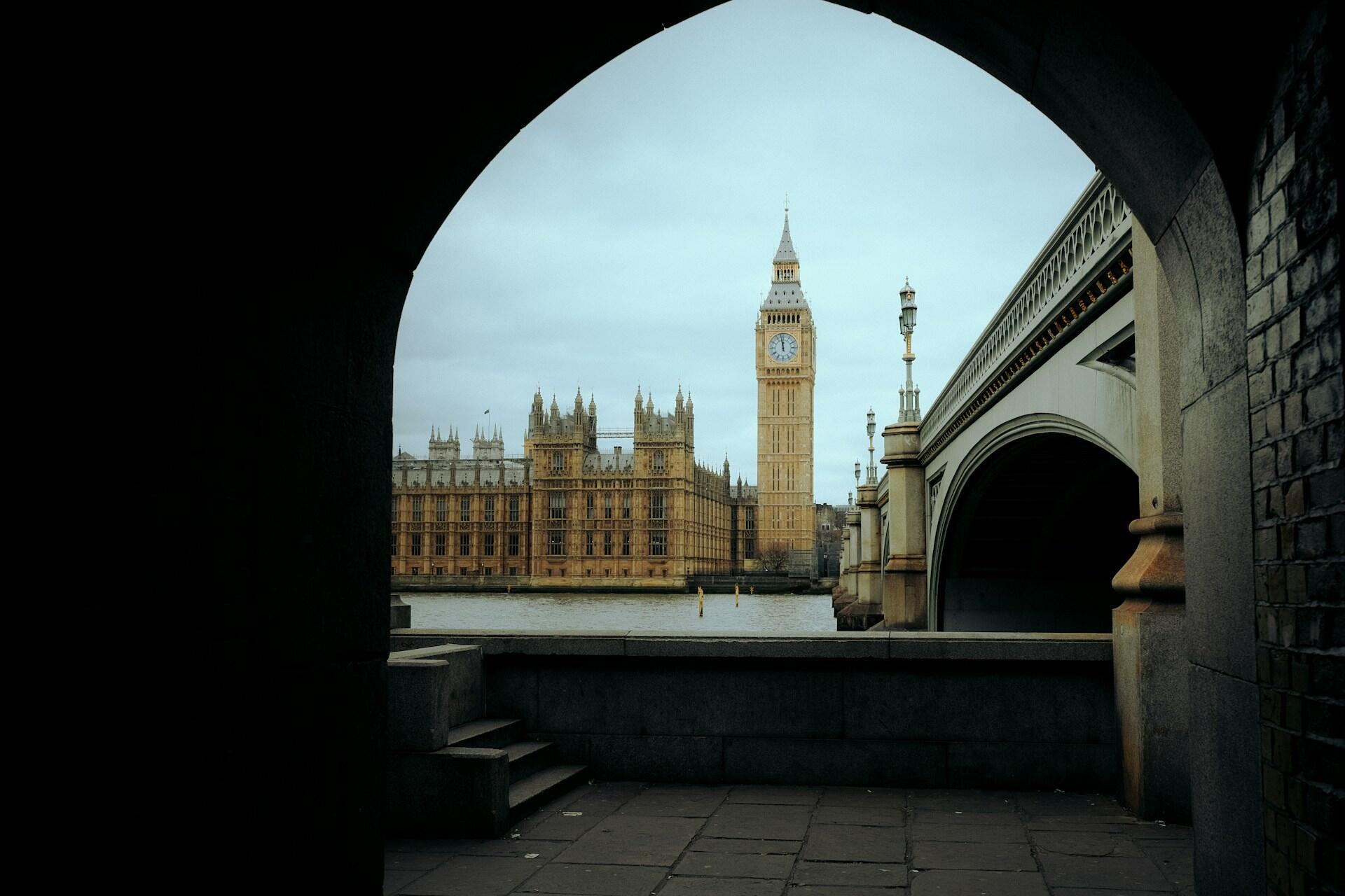 View of Big Ben and the UK Parliament through an archway.