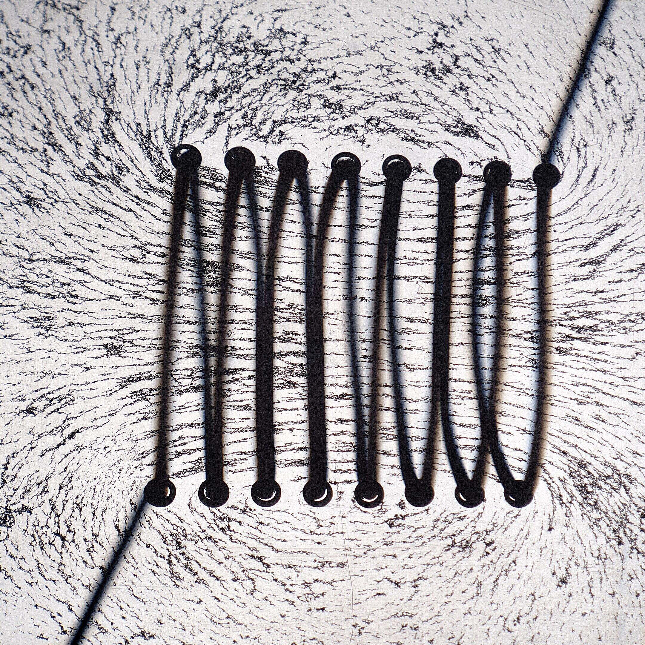 A coiled wire with its visible magnetic field. 