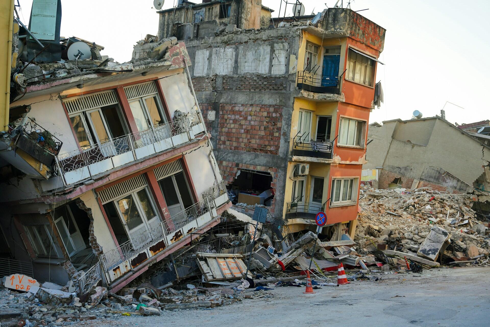 Two buildings left unsteady and crumbling after an earthquake.