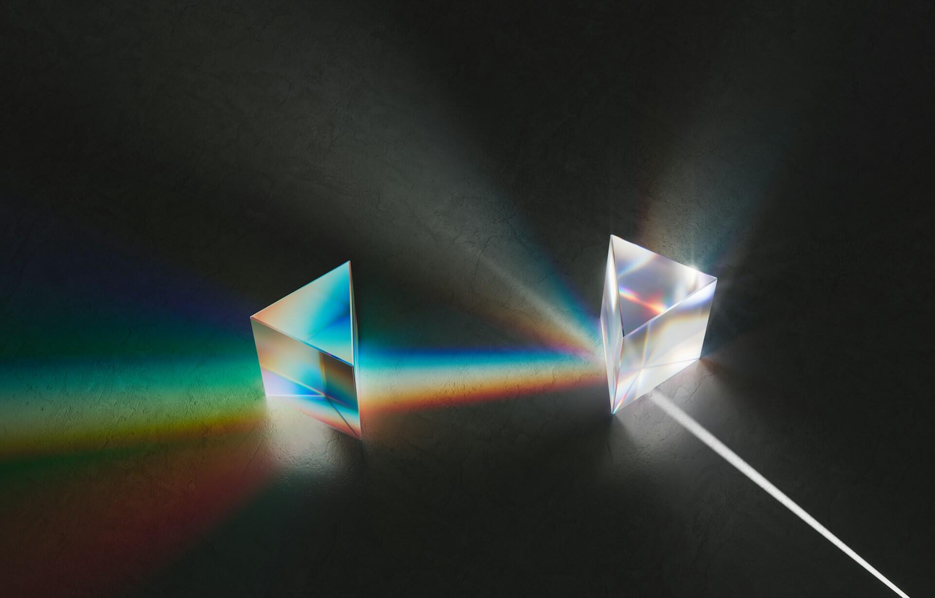Two prisms casting rainbow refractions. 