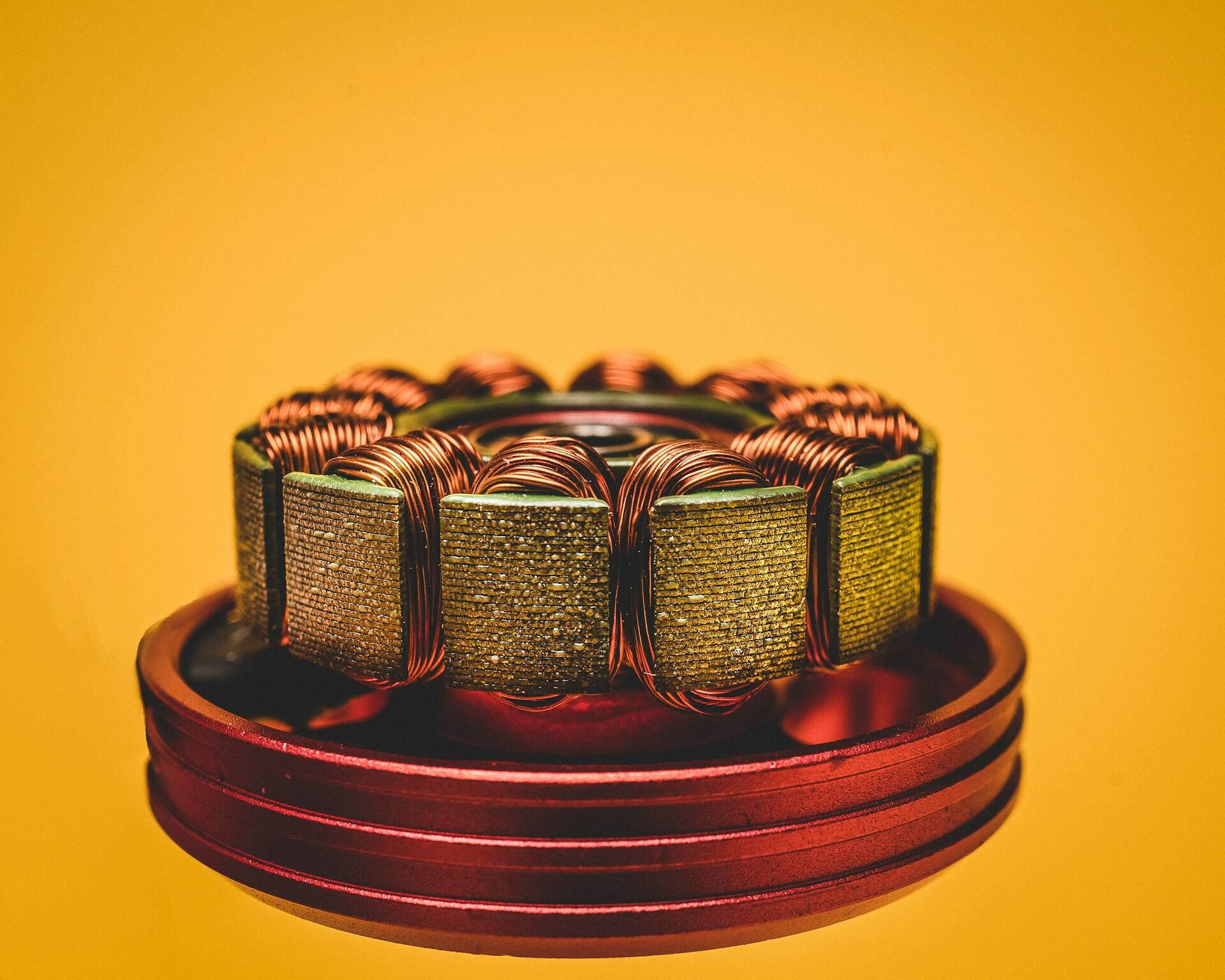 The inside of a motor exposing copper coils arranged in a circle. 