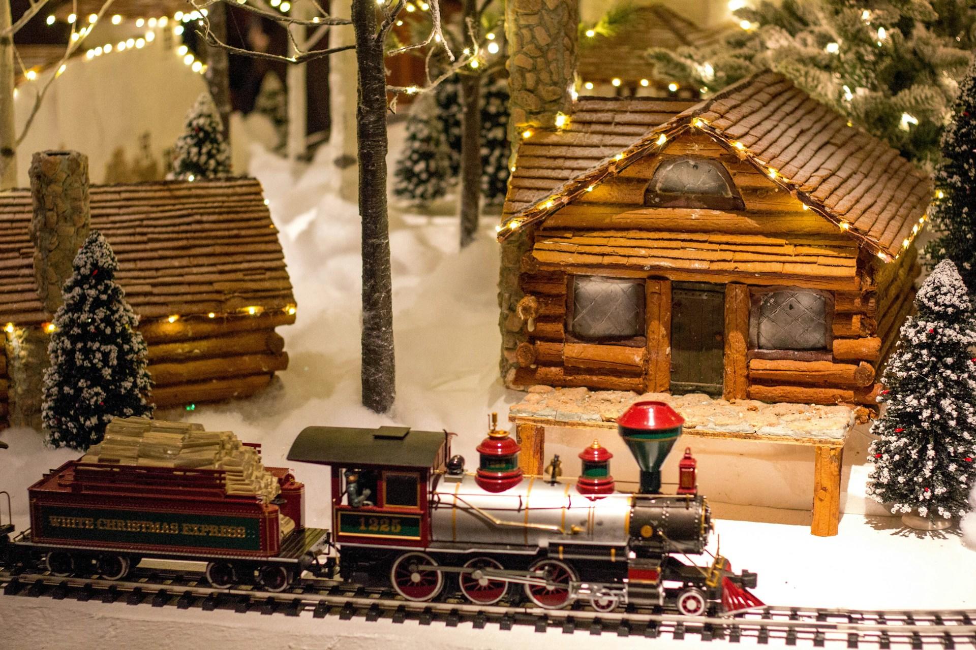 Miniature Christmas village scene with a train labeled 