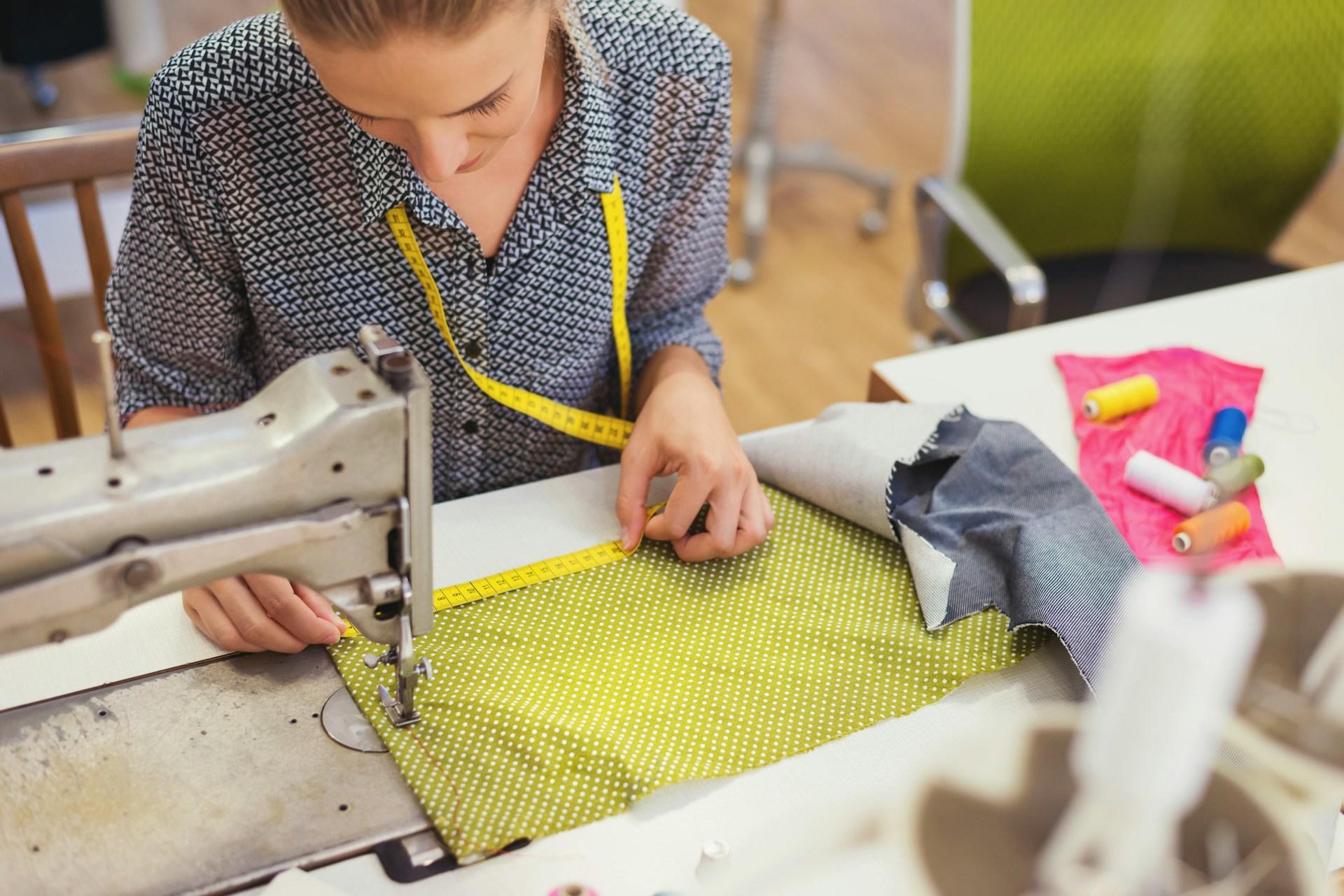 A woman working on a sewing machine.