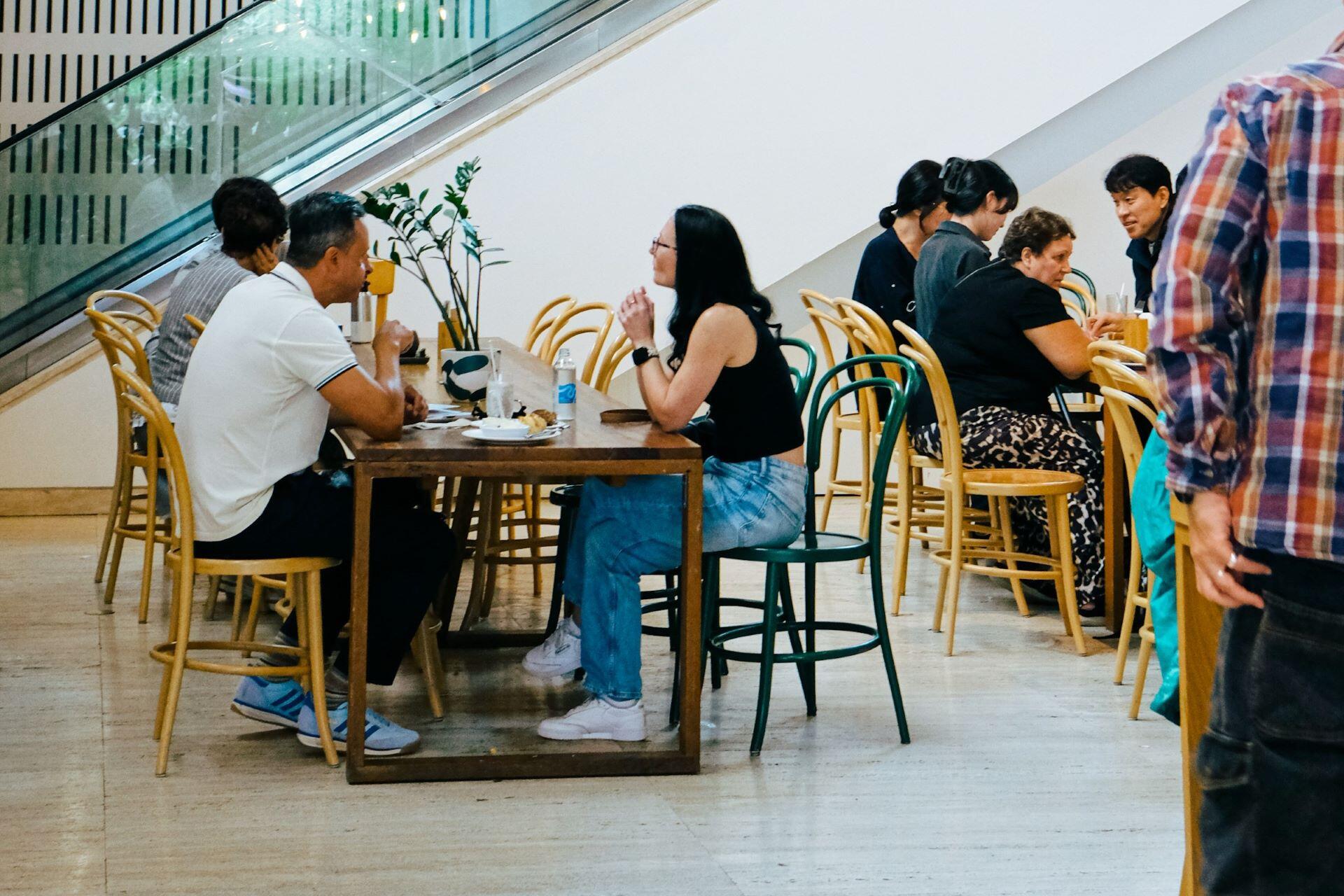 Friends talking in a café in Sydney, Australia