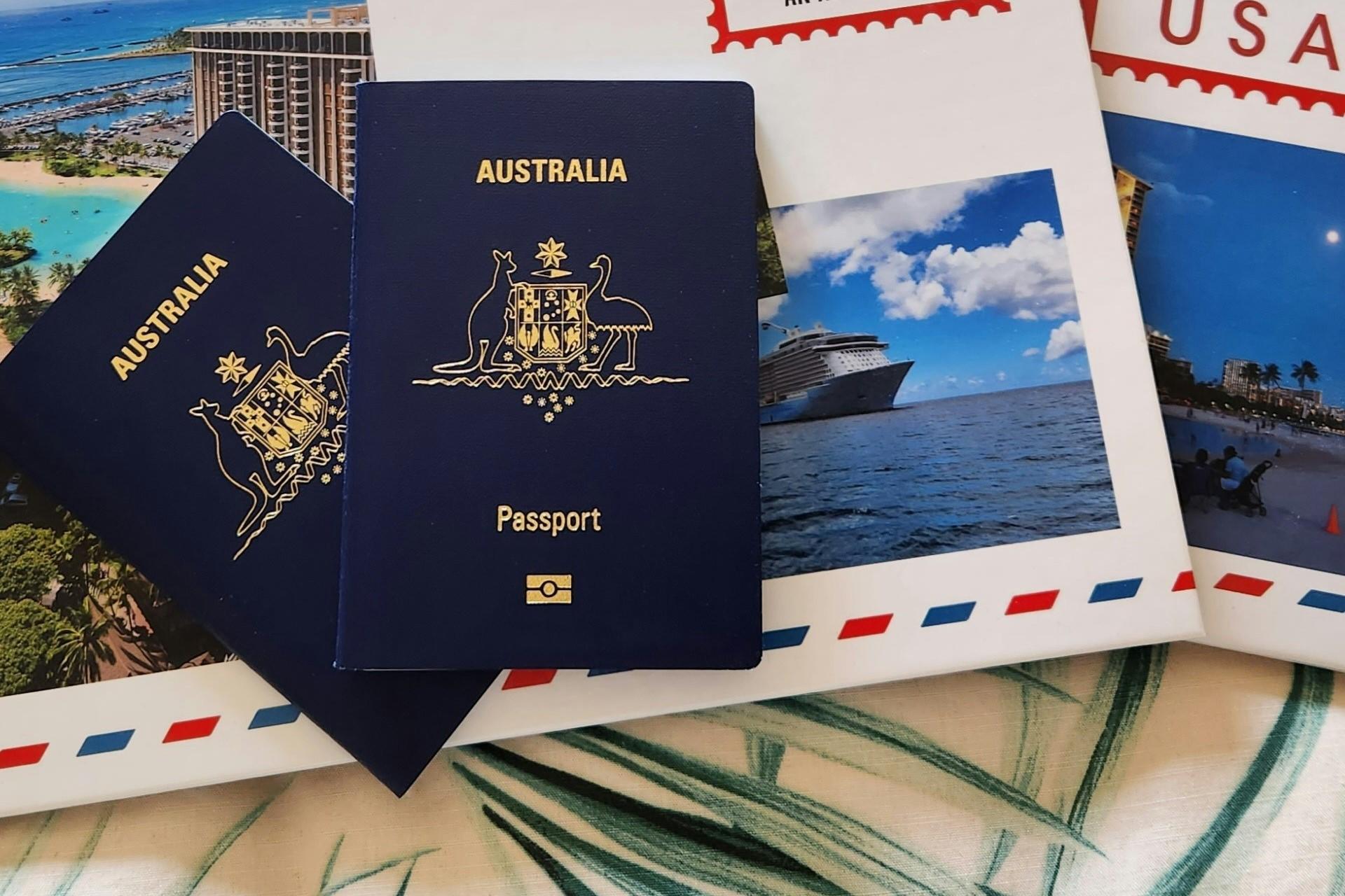 Two Australian passports next to a package holiday.