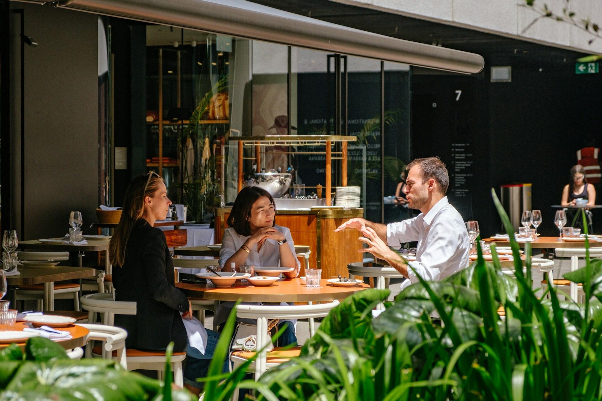 People talking at an outdoor café in Sydney, Australia