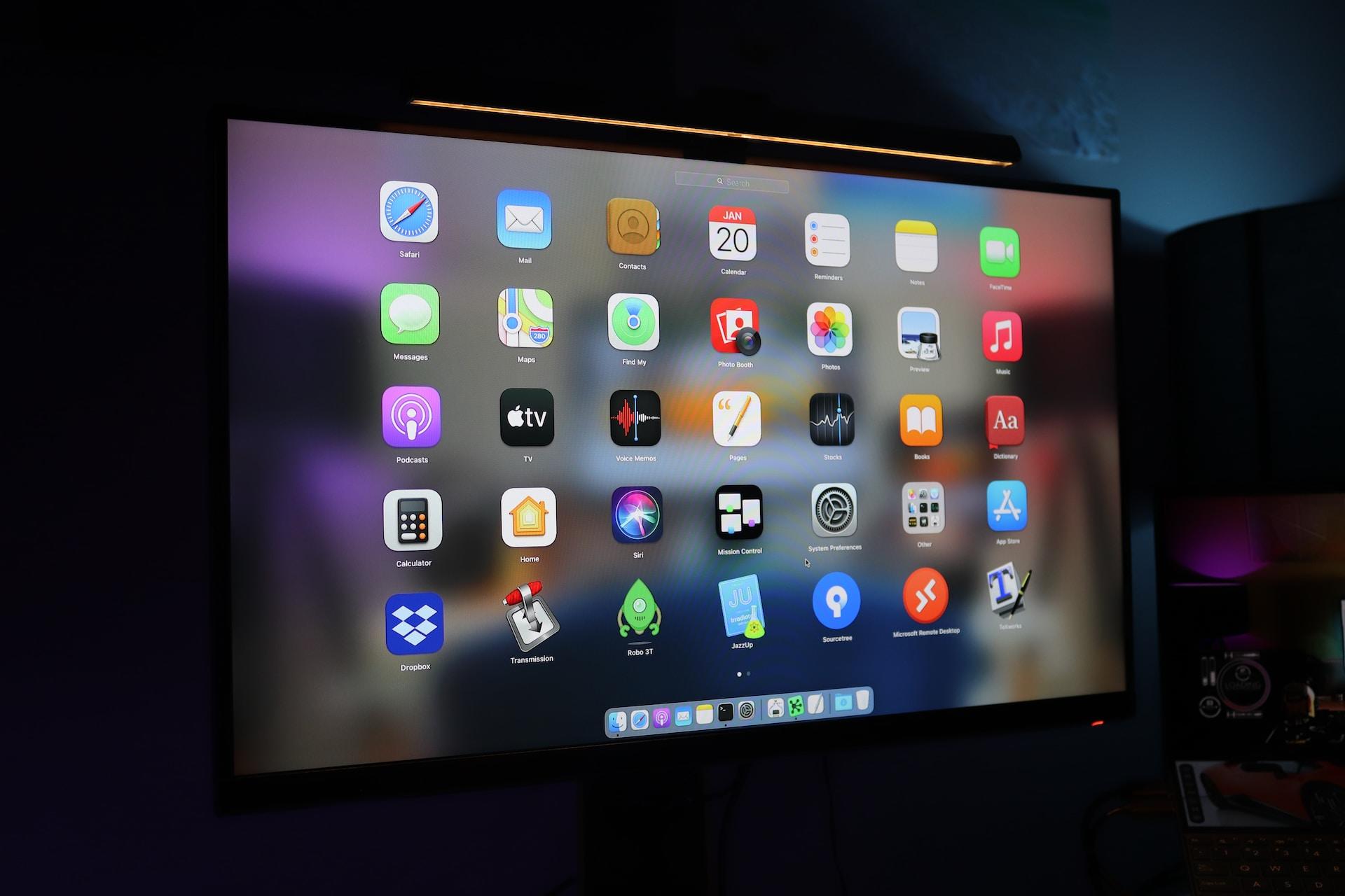 An LCD screen displaying a variety of application icons against a purple and black background.