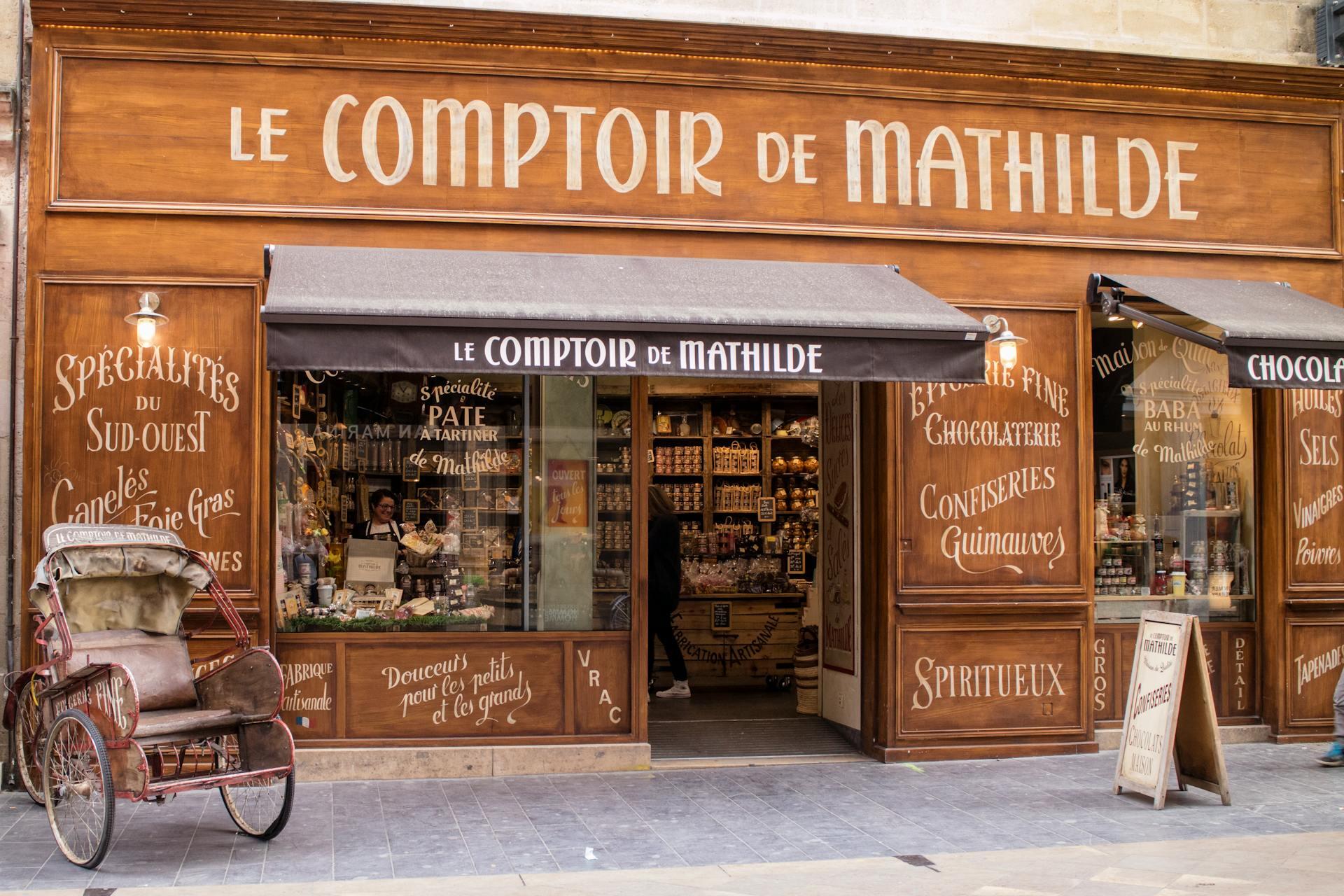 storefront of a French boulangerie called "Le Comptoir de Mathilde" with lots of French words written on the front