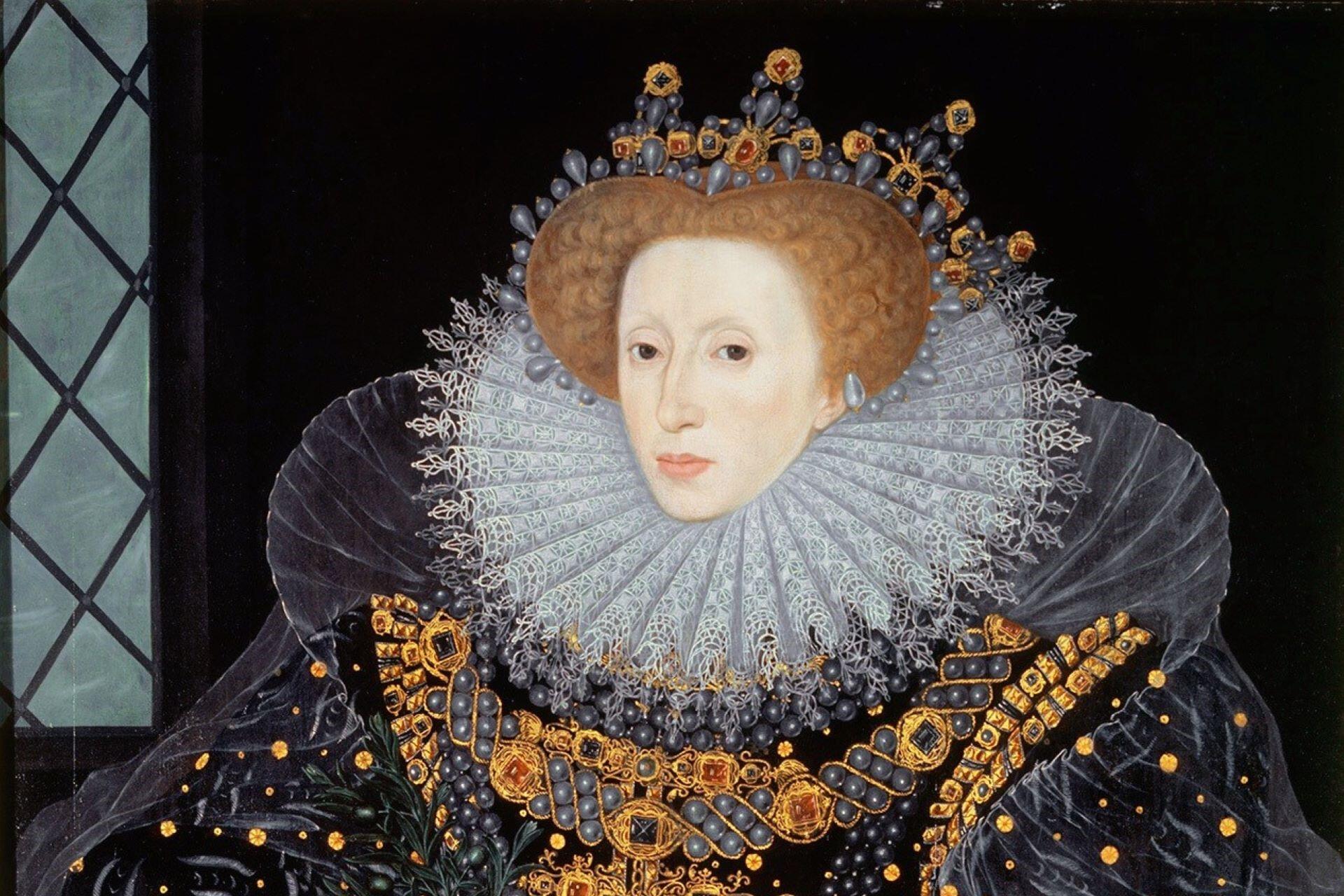 Portrait of a woman with very pale face makeup wearing an elaborate ruff collar, jewelled gown, and decorative headdress, facing forward against a dark background.