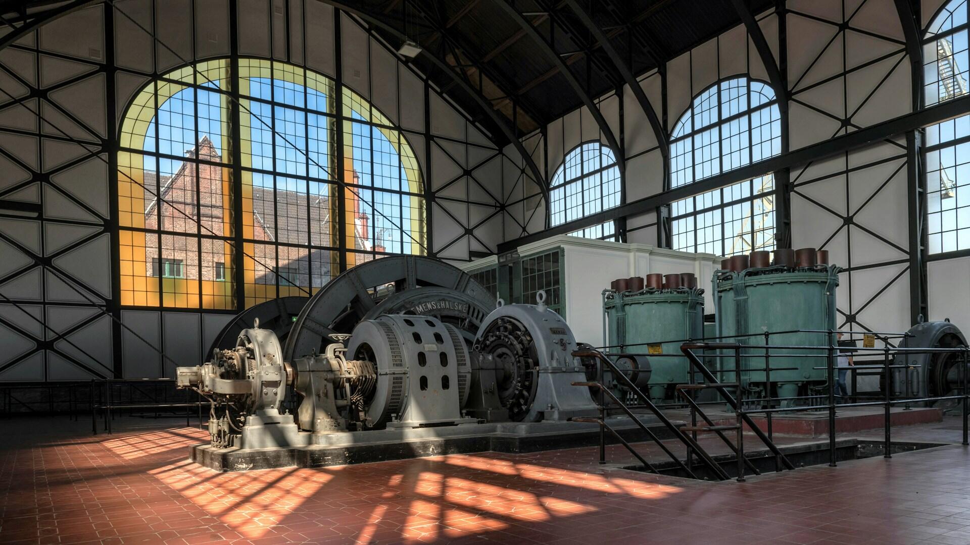 An electricity generation station in a room with large windows.