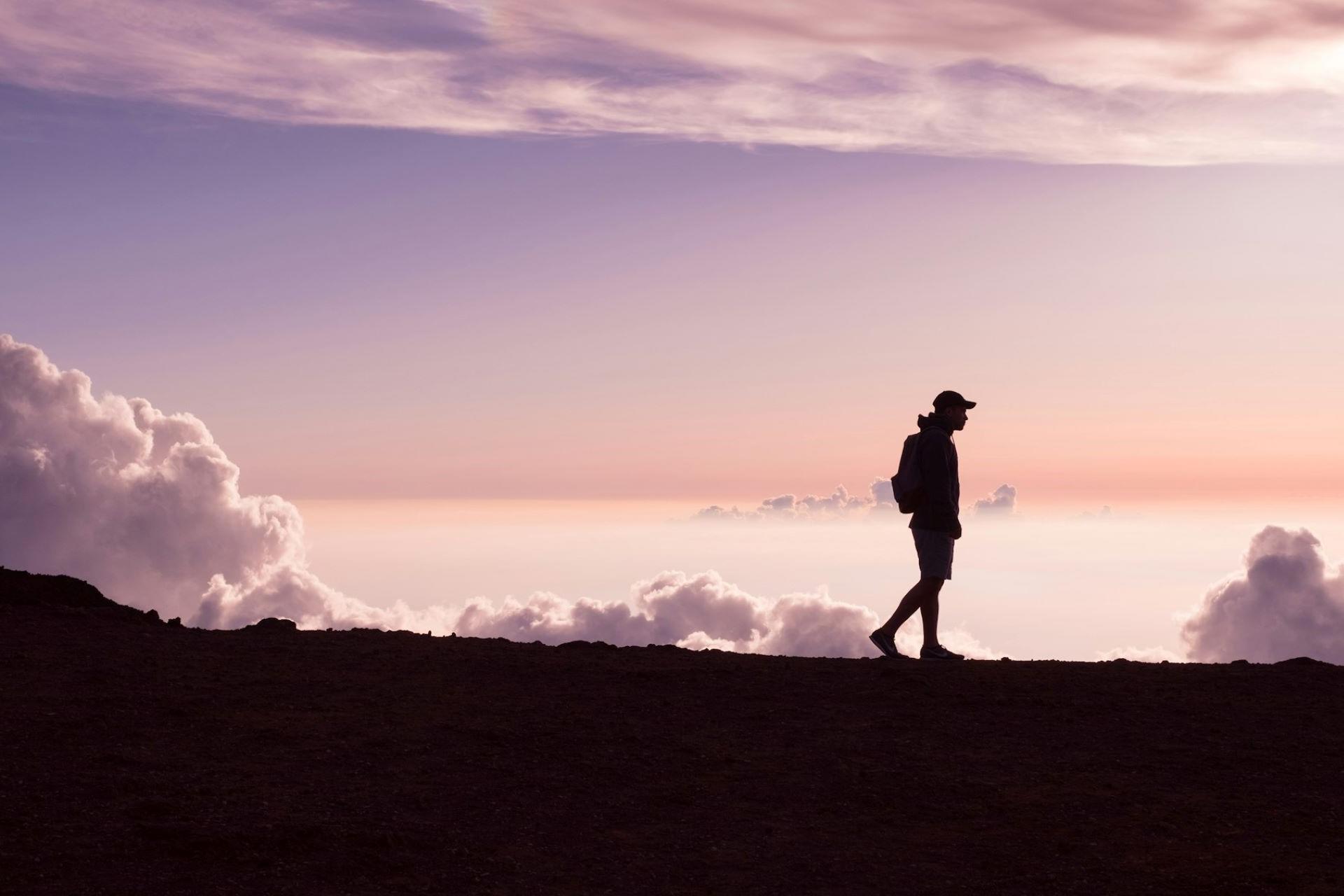 A person hiking at sunset.