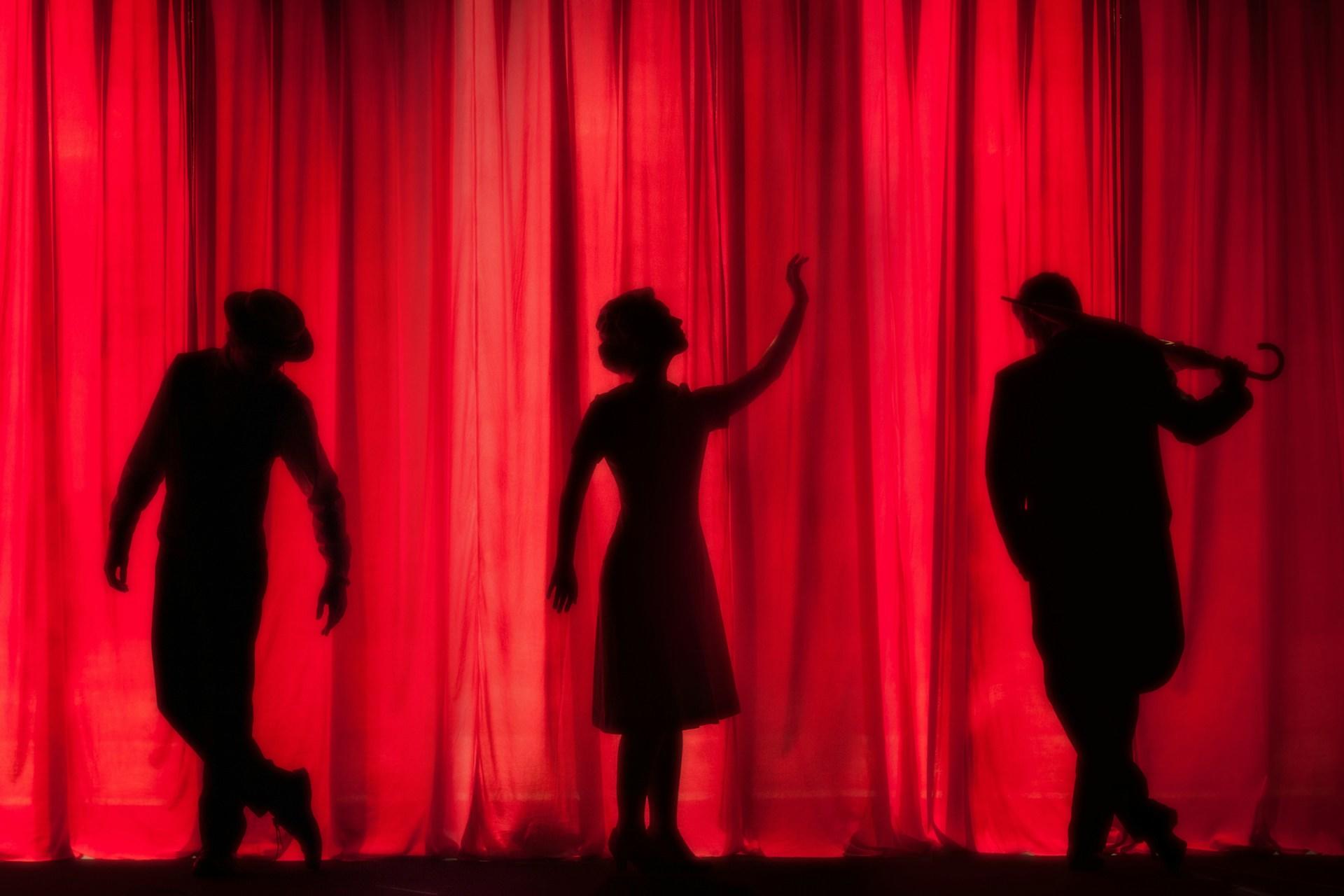 a group of people standing on a stage.