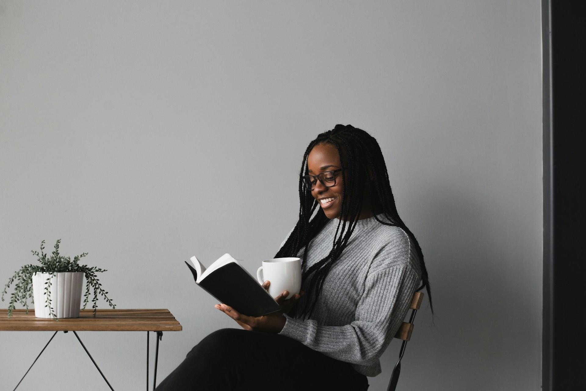Woman in white and black stripe long sleeve shirt sitting on chair